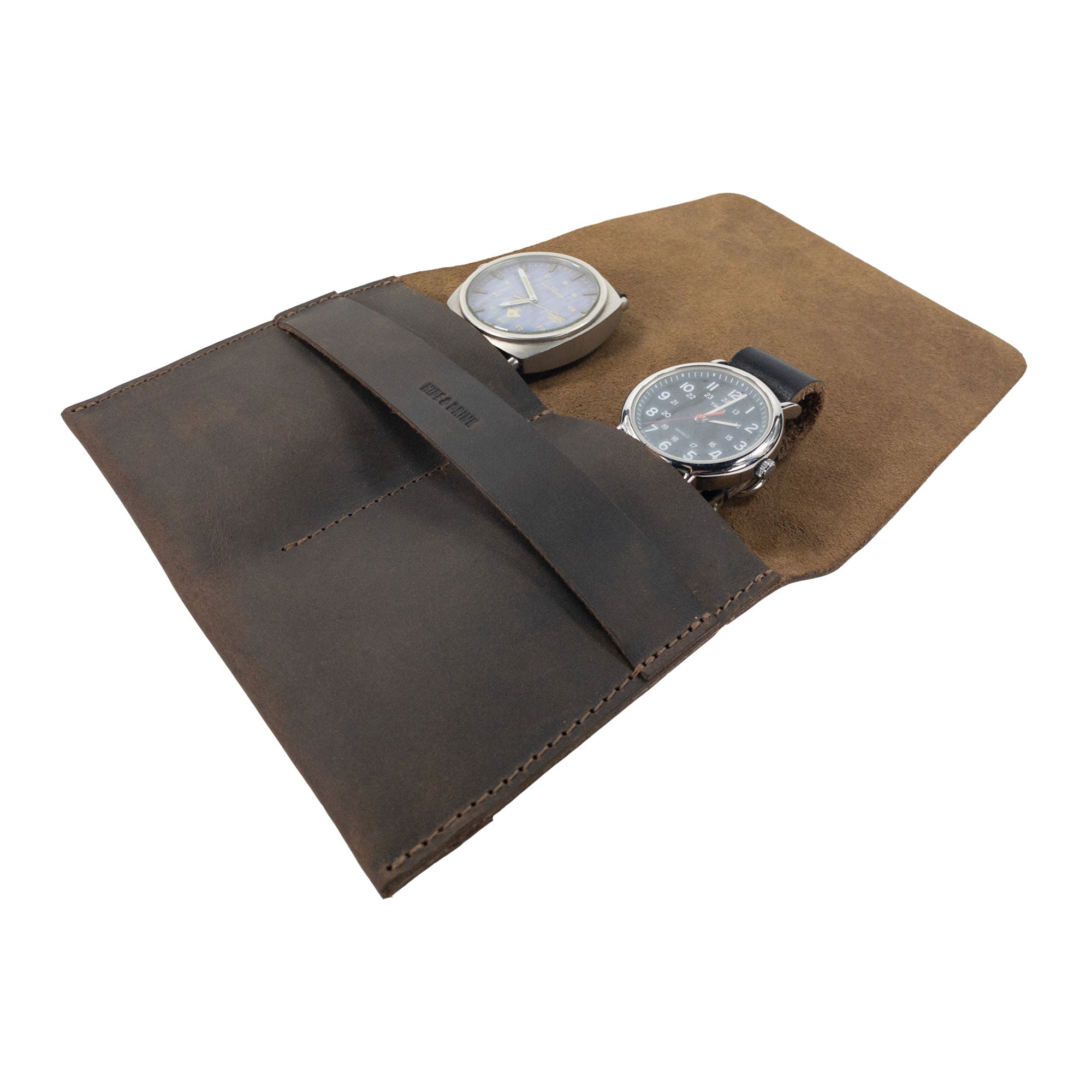 A functional perspective of the Hide & Drink Double Watch Case featuring two slot compartments for watches. With its vintage appeal wrapped in full grain leather, this rustic bag for men is a perfect travel companion, handcrafted and fire branded by artisans in La Antigua Guatemala and Oaxaca Mexico.