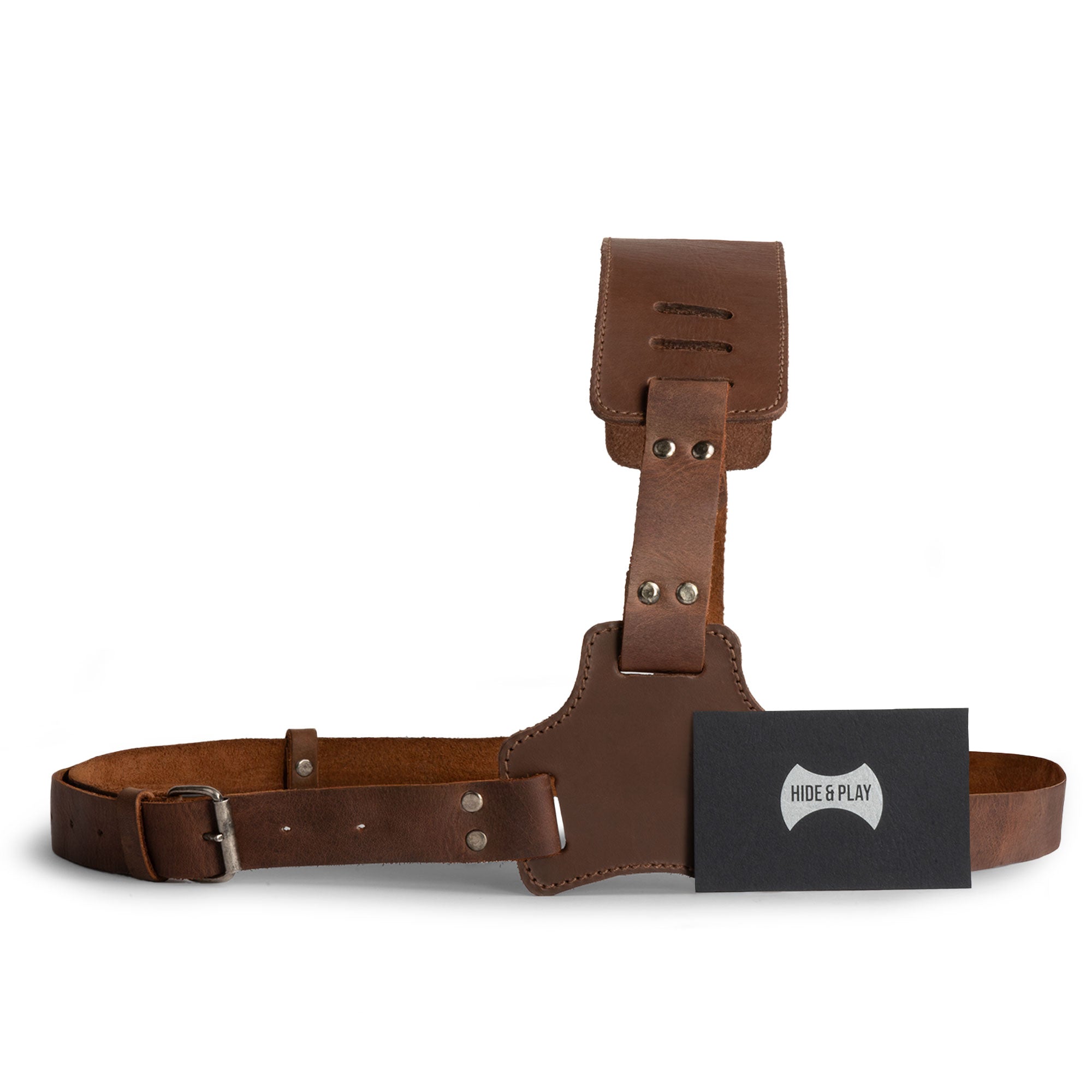Hide & Play Gladiator Harness displayed flat with a business card, emphasizing the quality materials and design. This Gladiator Shoulder Harness, made for cosplay and costume parties, is crafted from full grain leather with adjustable straps. Hand cut and hand sewn, this artisan piece is fire branded and proudly made in La Antigua Guatemala & Oaxaca Mexico.