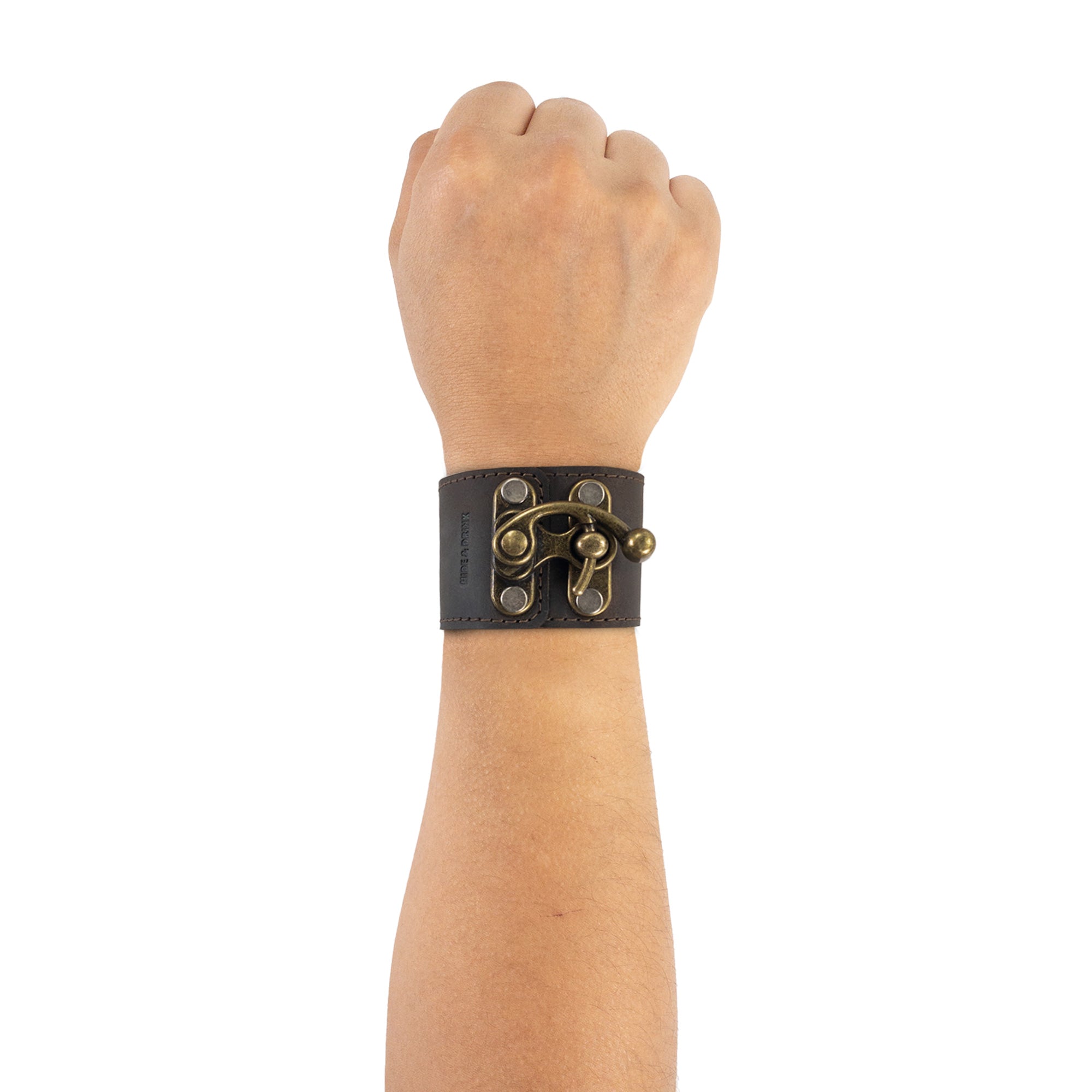 Person wearing the Hide & Drink 8 Inch Wristband with Vintage Clasp on their wrist, showcasing its stylish design and the quality of the Full Grain Leather. Crafted through small batch production methods, each piece is hand cut, hand sewn, and fire branded in La Antigua Guatemala & Oaxaca Mexico.