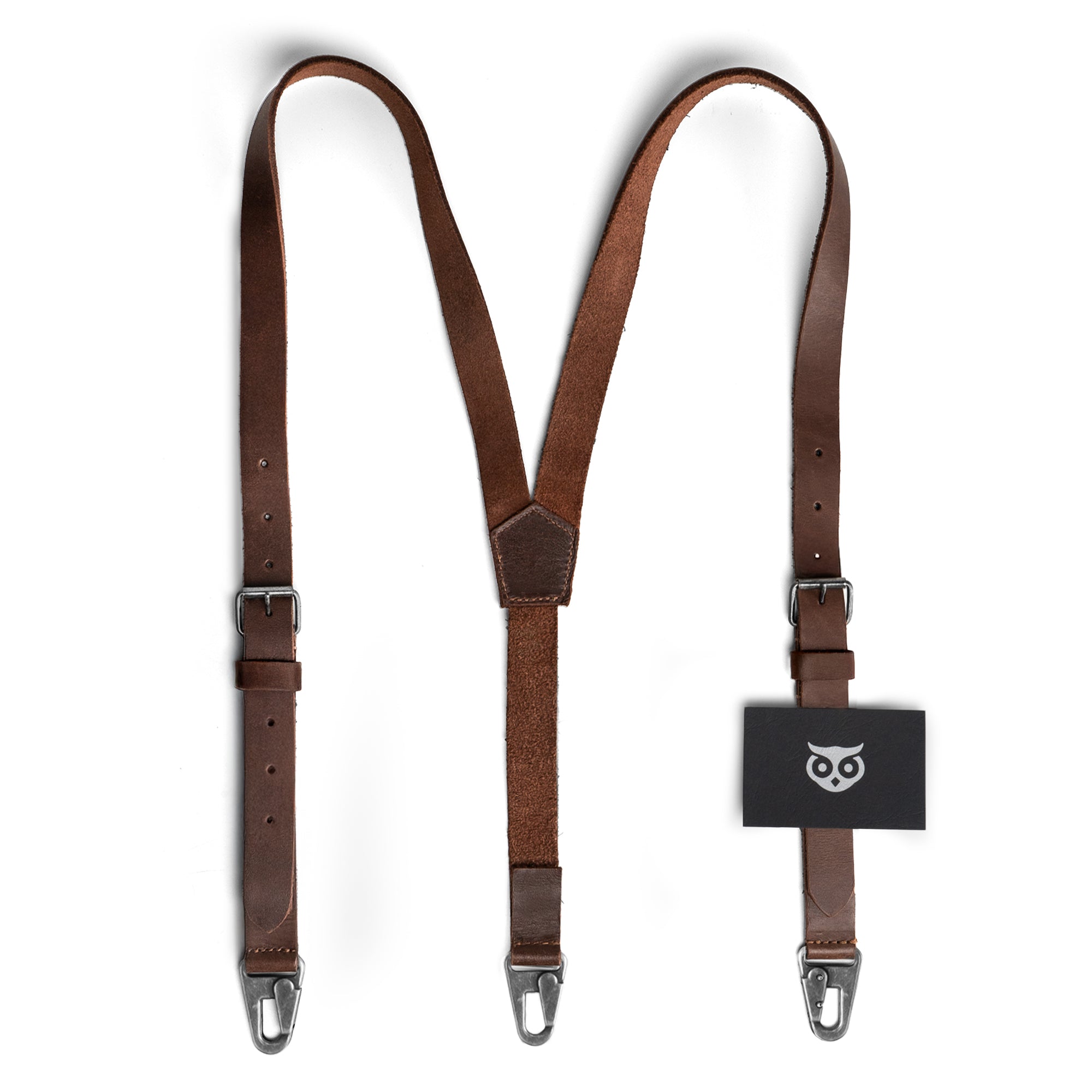 Hide & Drink Rustic Slim Suspenders displayed with card tag, showcasing high-quality Full Grain Leather and X back design. A stylish choice for weddings with handmade, artisan appeal from La Antigua Guatemala.