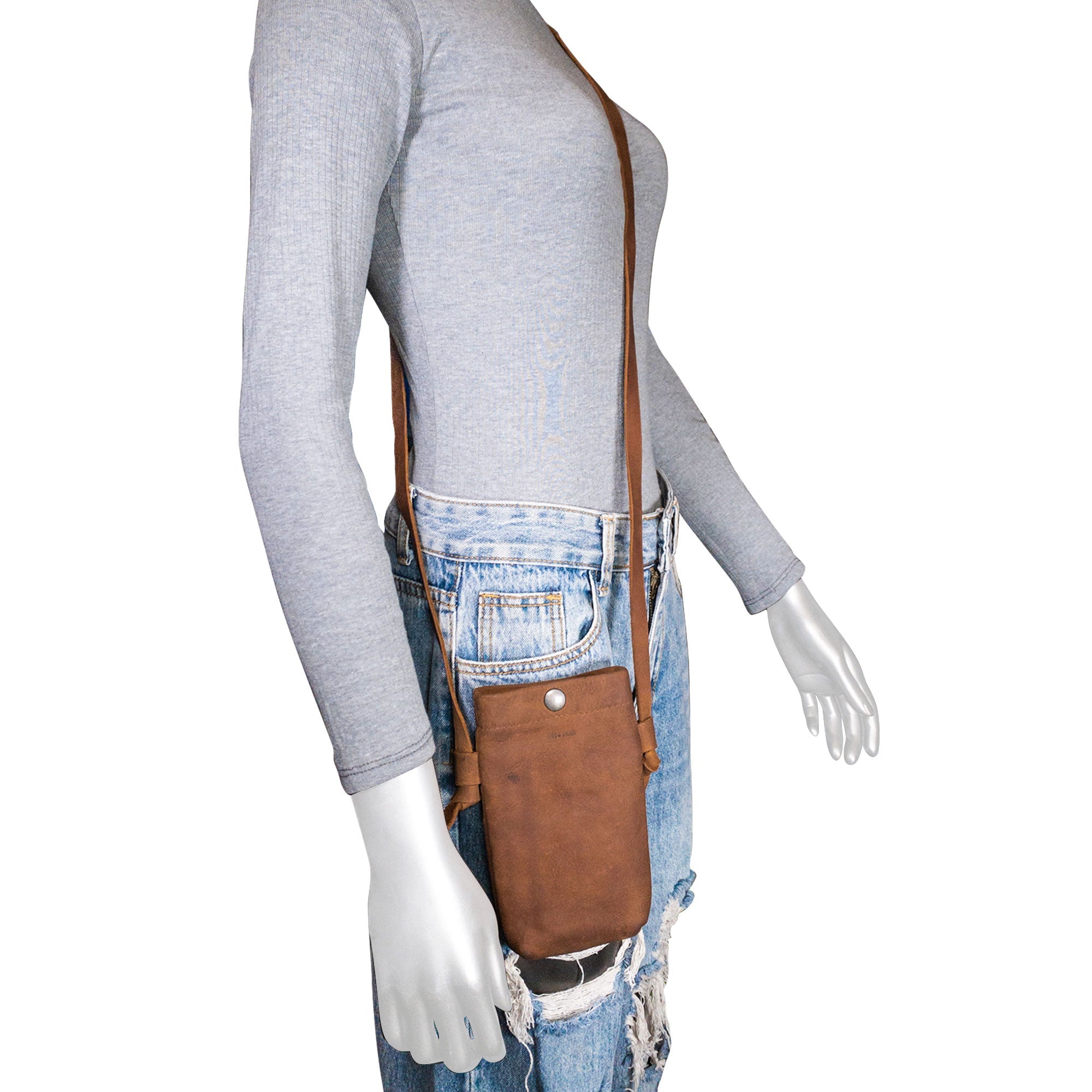 The Hide & Drink Cell Phone Shoulder Bag modeled on a mannequin, showcasing how it can be worn as a handy crossbody bag or shoulder bag for cellphone storage. The artisan handmade quality in full grain leather highlights the thoughtful design perfect for everyday use.