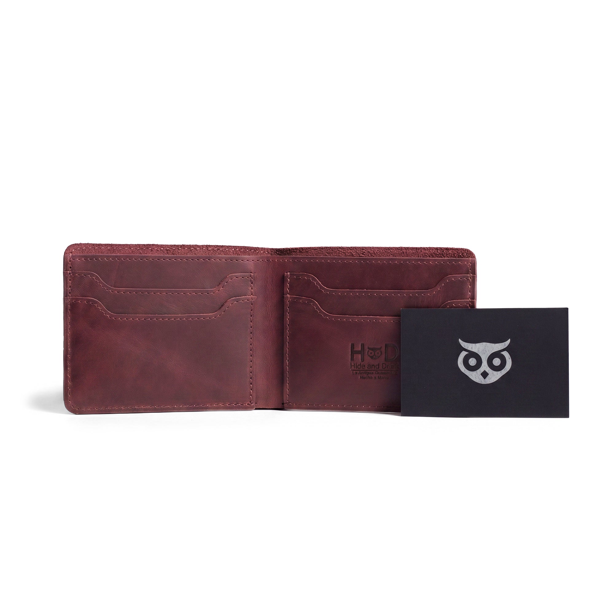Detailed view of the dark brown Classic Wallet from Hide & Drink with an open section for cards. This Classic Bifold Wallet serves as a sturdy storage case for identification, made from durable Full Grain Leather. A must-have travel accessory, showcasing artisan skills through small batch production methods, hand cut and sewn in La Antigua Guatemala & Oaxaca Mexico.