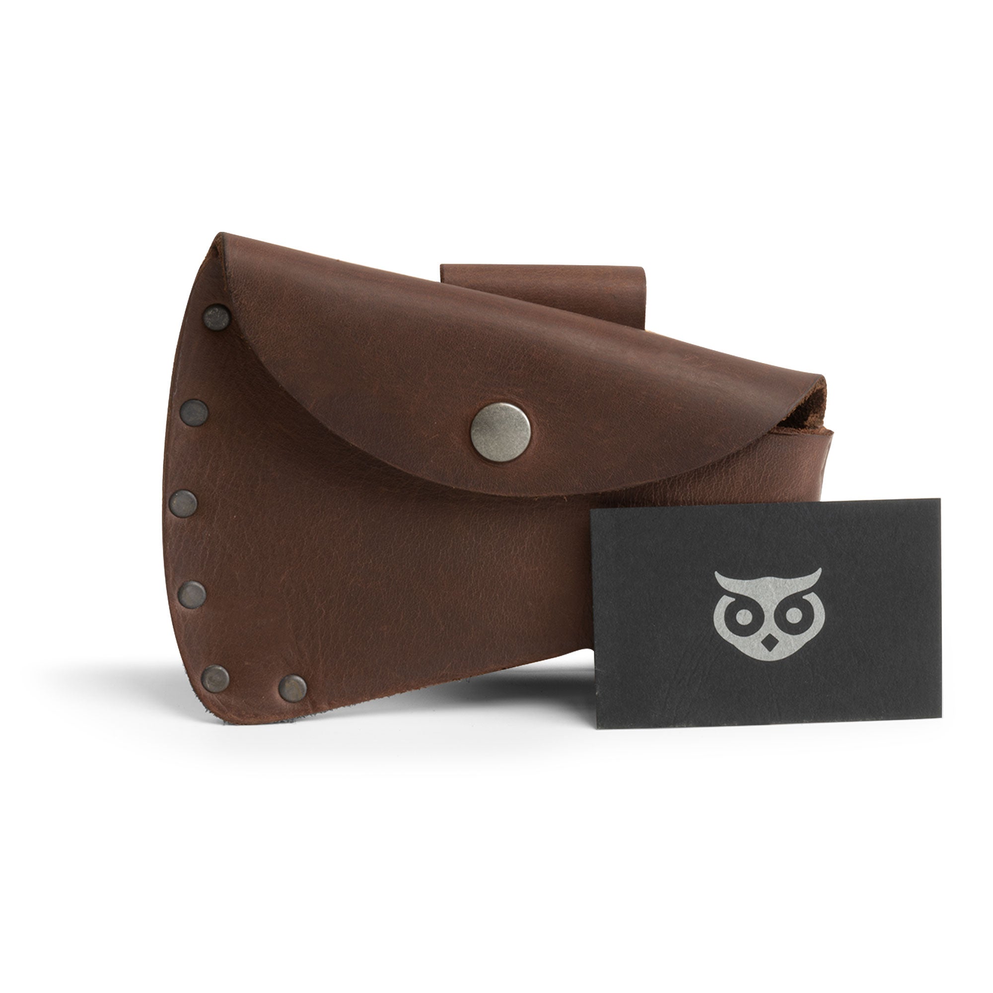 Hide & Drink Hatchet Head Sheath presented alongside a business card, highlighting full grain leather construction and functional design as a holster for 1.5 in. belts. This blade cover acts as an axe head case for lumberjack outdoors work essentials, handmade in La Antigua Guatemala & Oaxaca Mexico.