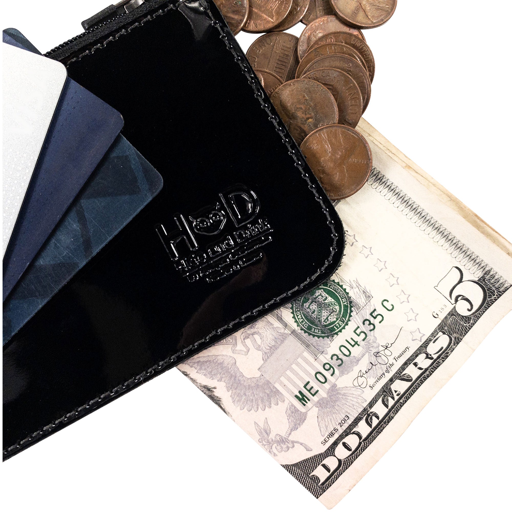 Close-up of Hide & Drink Zippered Wallet displaying cards, folded bills, and coins, perfect as a travel accessory. This zippered wallet is expertly made from full grain leather, showcasing hand cut and hand sewn details inspired by artisan techniques from La Antigua Guatemala & Oaxaca Mexico.