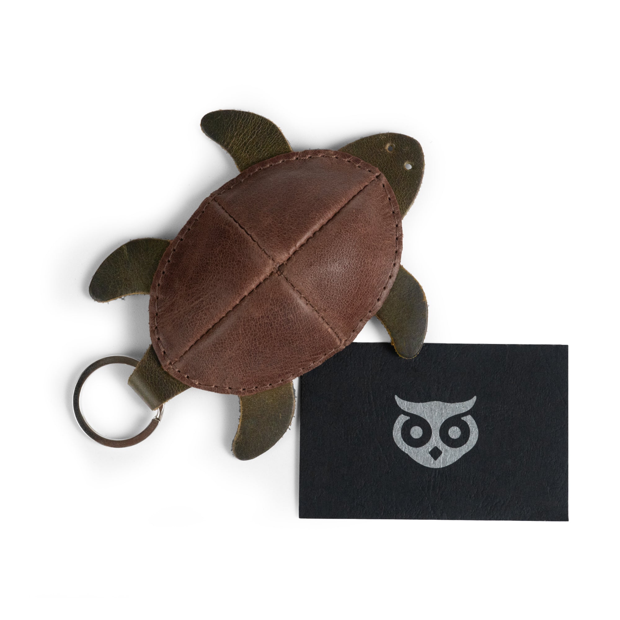 Turtle Mini Pouch Keychain by Hide & Drink, presenting the keychain alongside a business card, highlighting its artisan quality. This Full Grain Leather Turtle Coin Purse is ideal for organizing small items, showcasing handmade excellence from La Antigua Guatemala.