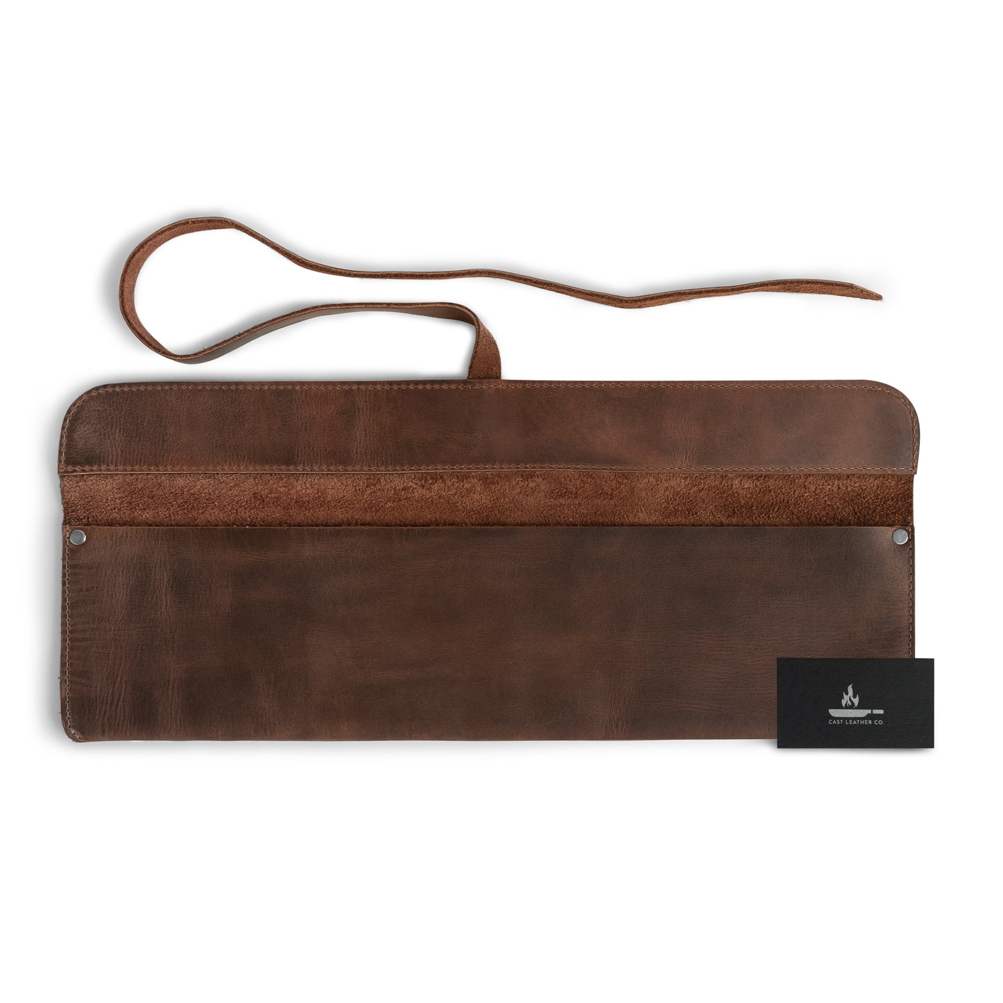 Cast Leather Co. Single Leather Knife Case, featuring a styled presentation alongside a business card. This unique storage option is an ideal kitchen small storage bag, showcasing the craftsmanship of full grain leather from La Antigua Guatemala. Designed for the traveling chef, it's perfect for transporting knives securely.