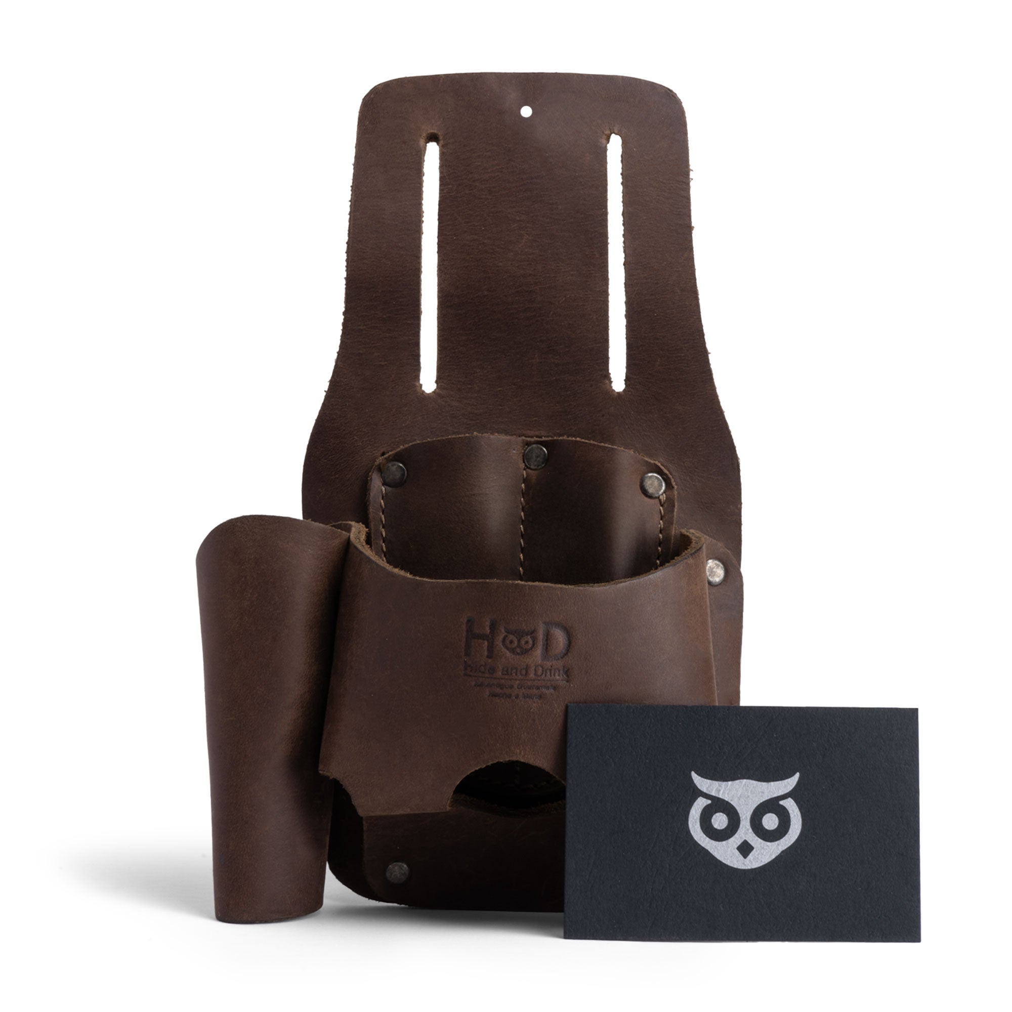 Hide & Drink Tape And Knife Holder with an included card showcasing its quality. This versatile Tape & Knife Holder is perfect for easily organizing your tools. Made from premium full grain leather, it works as a tool case or screwdriver holster. Artisan crafted in La Antigua Guatemala, ensuring a unique handmade touch.