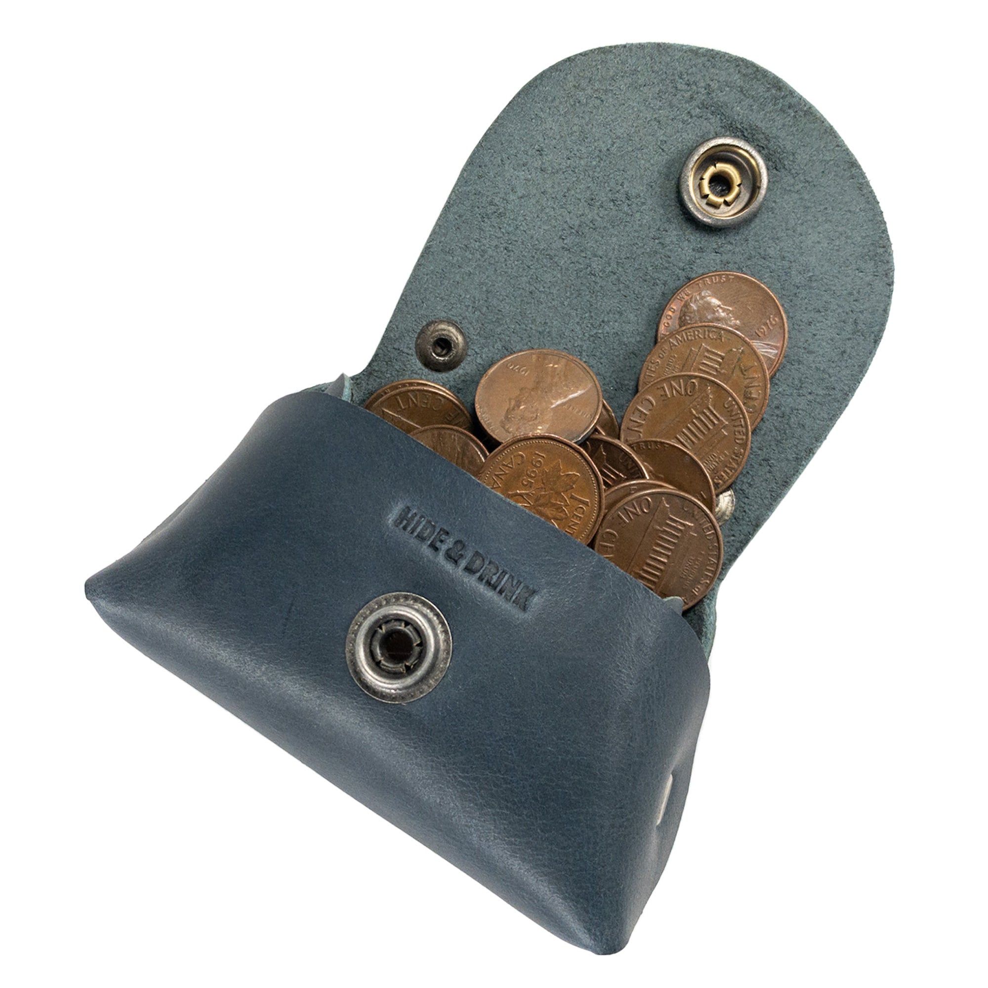 Inside view of the Tiny Handbag Keychain by Hide & Drink, filled with coins to illustrate its usability. This keychain, made from Full Grain Leather, is a great example of handmade craftsmanship from StockyardX, highlighting the artisan skills from Oaxaca Mexico.