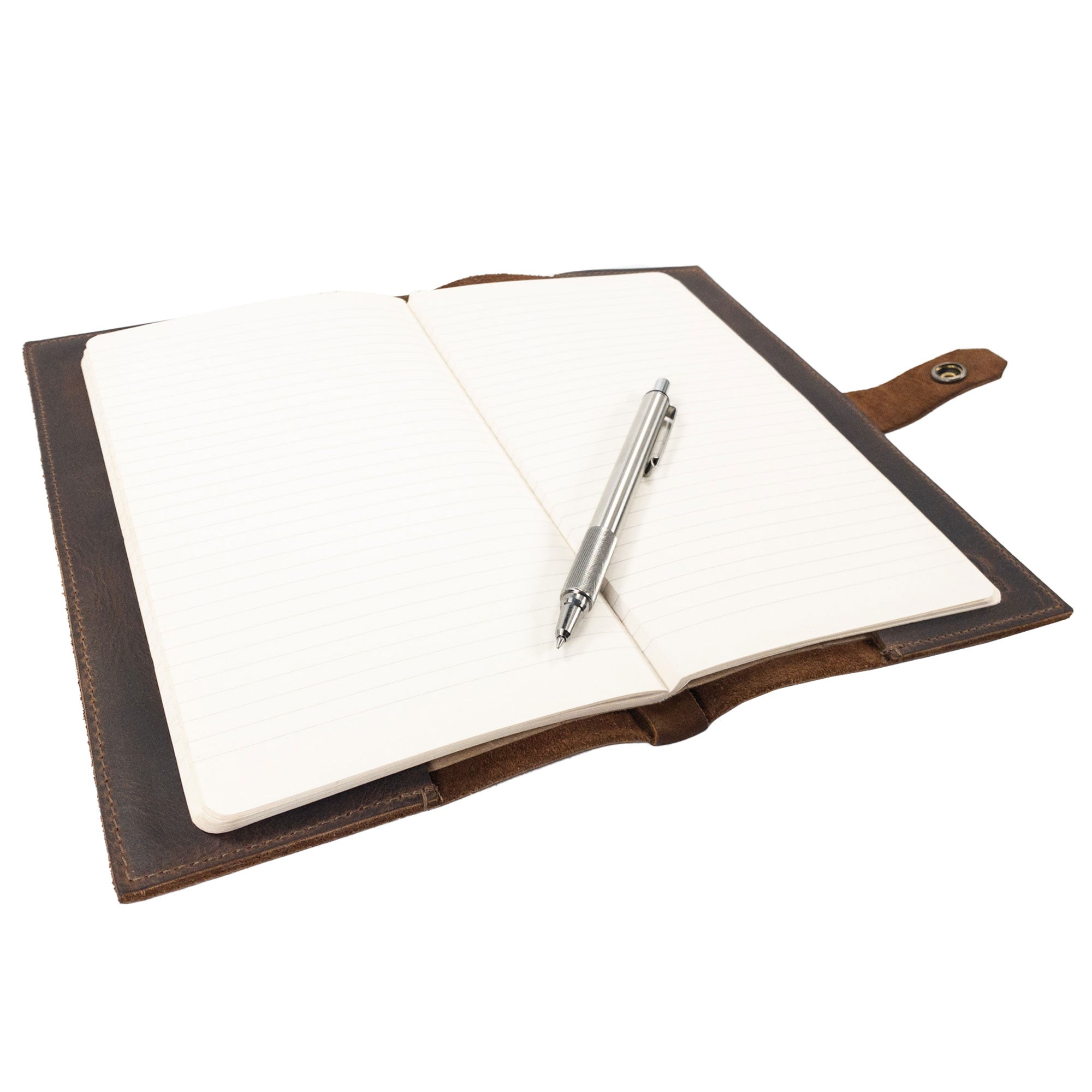 Riveted Field Note Cover for Moleskine (5 x 8.25 in.) Notebook NOT Included from Hide & Drink, shown with a pen on its lined pages. This full grain leather cover combines function and style, highlighting the hand cut, hand sewn quality crafted in La Antigua Guatemala & Oaxaca, Mexico.