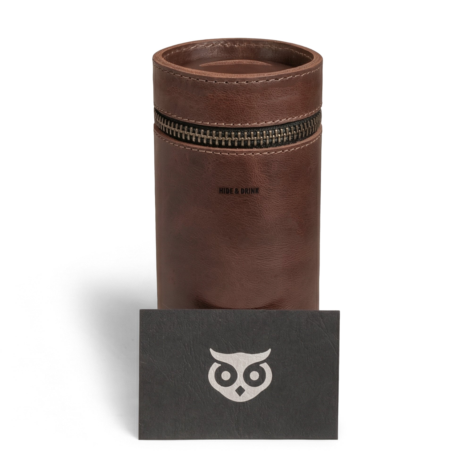 The Bucket Coin Release by Hide & Drink, elegantly displayed alongside a branded card, represents a perfect blend of function and style. This Money Box and Piggy Bank Bucket, crafted from Full Grain Leather, is a zippered pouch that serves as a Cash Organizer and Coin Case, symbolizing artisan craftsmanship from Mexico.