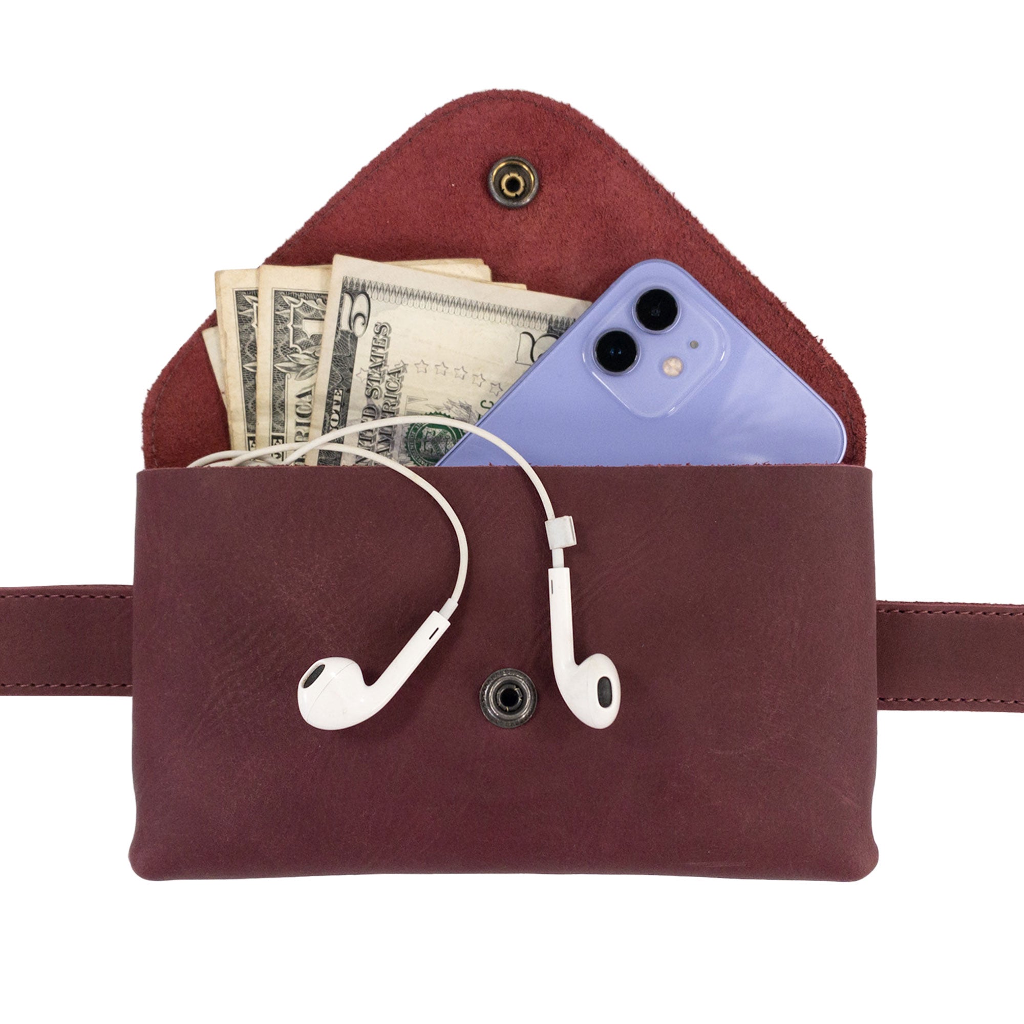 The Fancy Fanny Pack by Hide & Drink, expertly crafted from full grain leather, displayed with artisan tags. This waist pouch combines vintage charm and modern convenience for digital nomads.