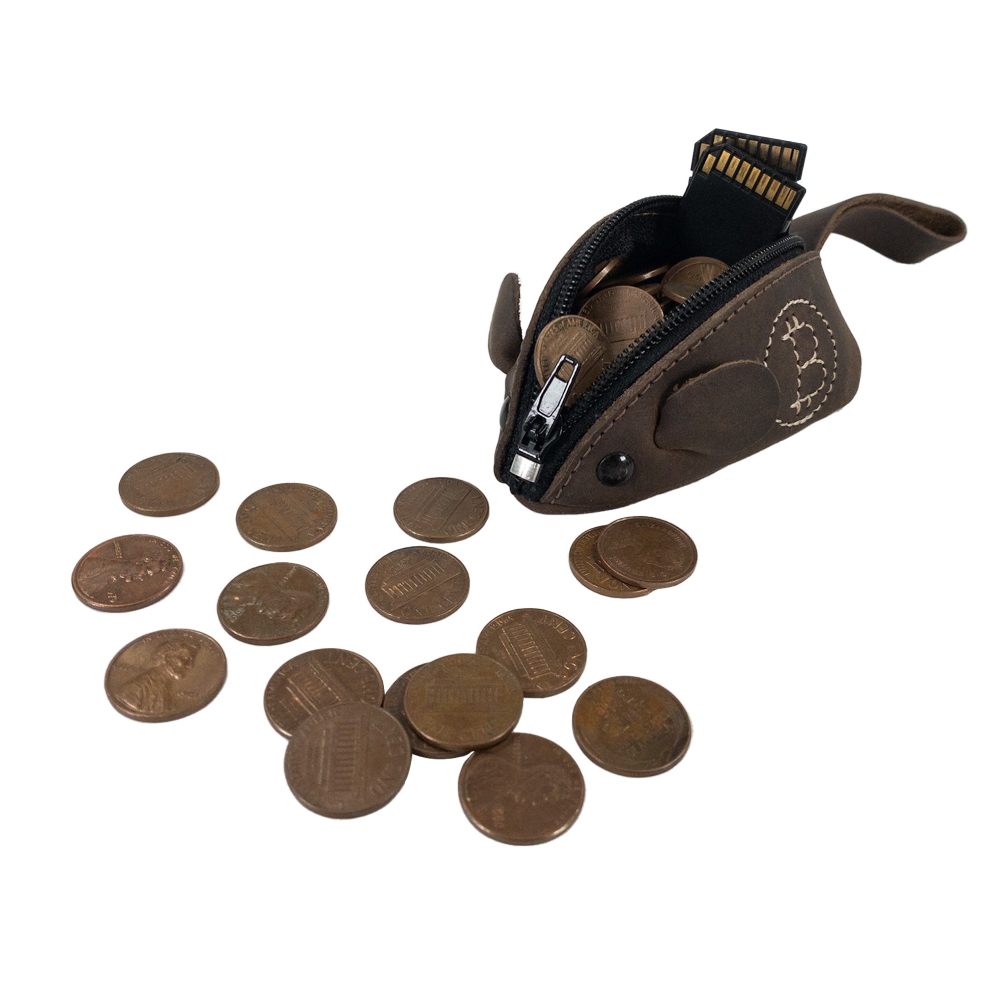 The Mouse Coin Pouch by Hide & Drink, filled with coins, offers a practical solution for coin organization. This mouse-shaped pouch, made from premium full grain leather, is a lovely travel accessory that showcases small batch production techniques and artisan craftsmanship from La Antigua Guatemala and Oaxaca, Mexico.