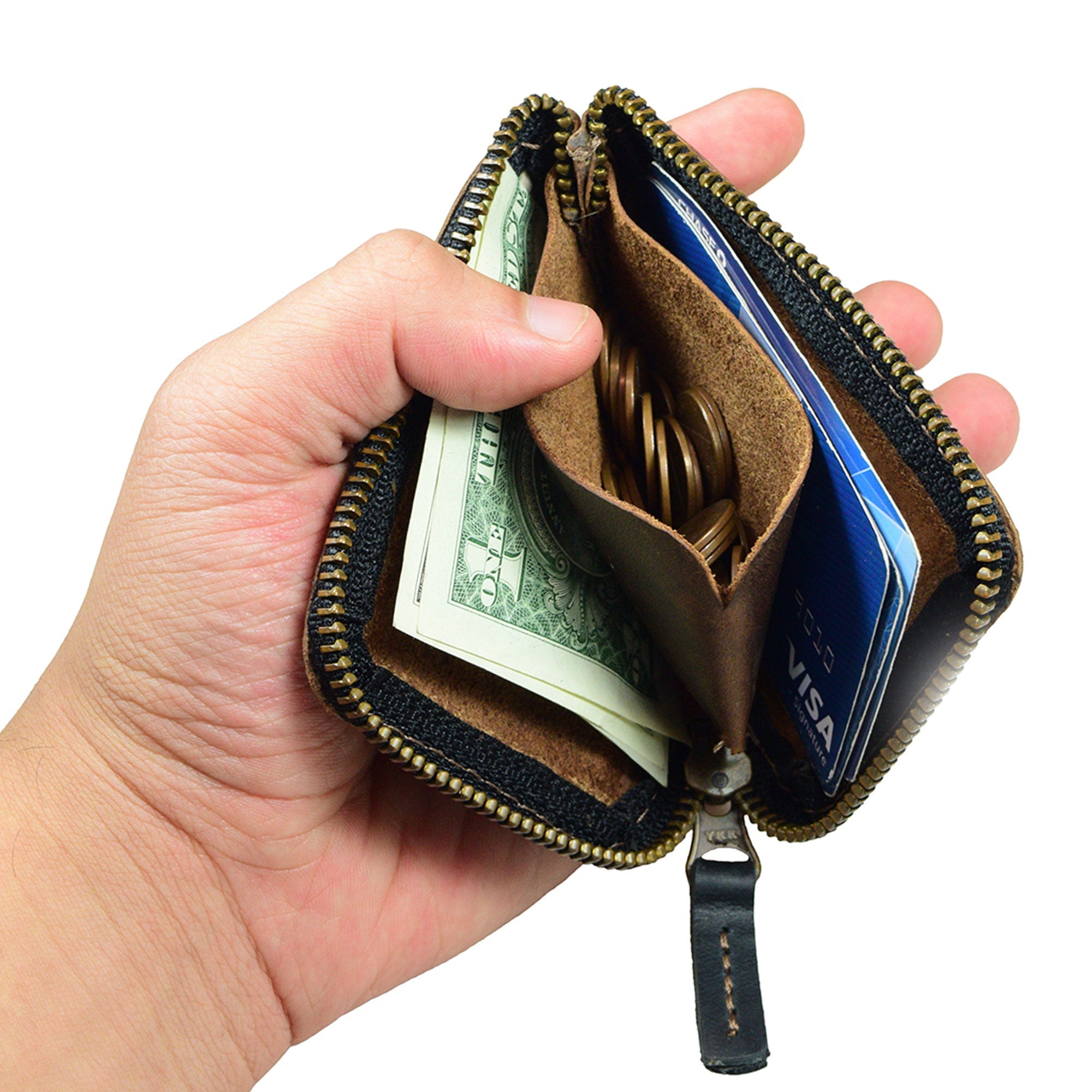 A user showcasing the Hide & Drink Card Pocket Wallet in hand, demonstrating its practical use. This zippered card wallet for men and women serves as a coin pouch and money holder, crafted from full grain leather in small batches by artisans in La Antigua Guatemala.