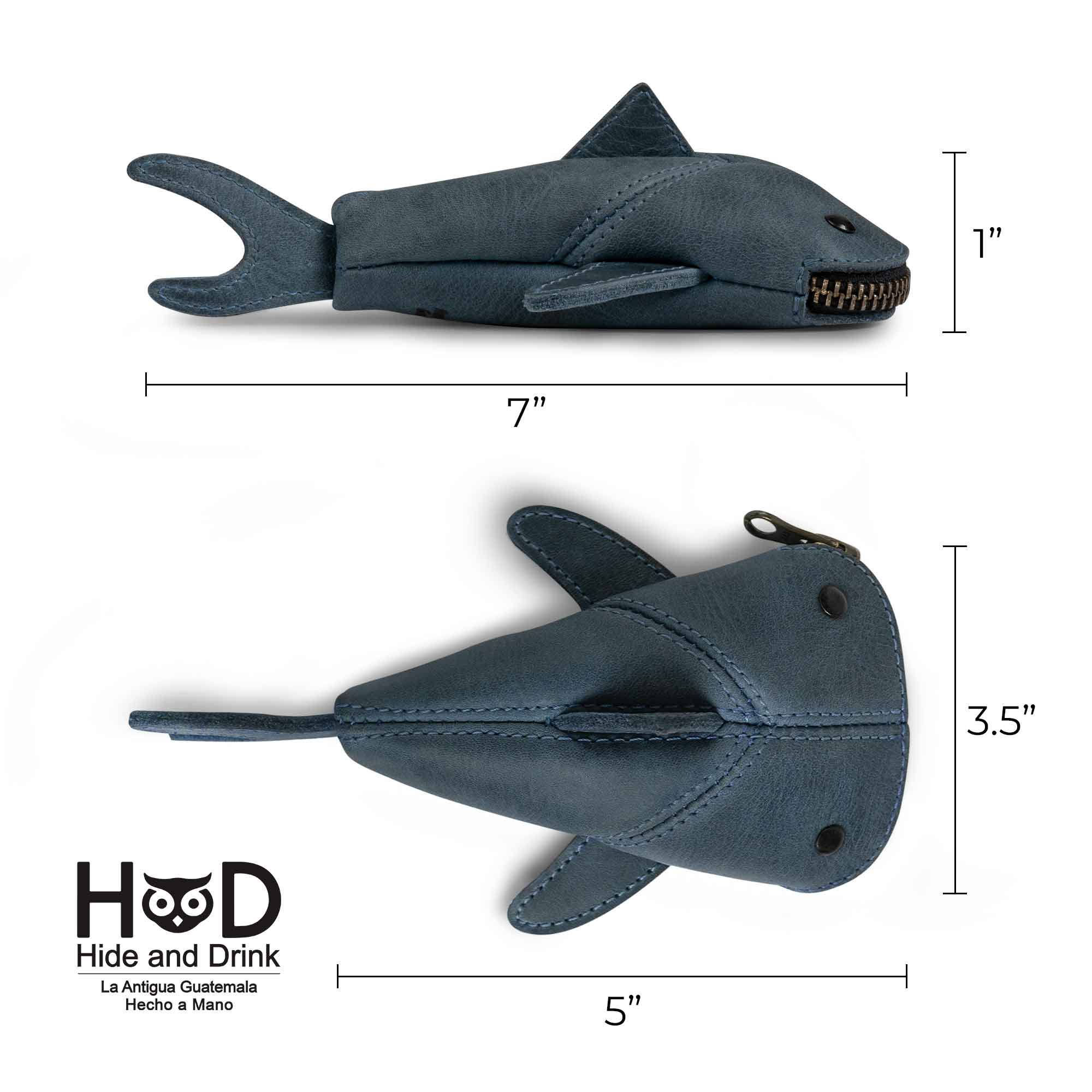 Dimensions of the Hide & Drink Leather Shark Pouch highlighted in a graphic. This small shark-shaped leather pouch is both a charming Leather Coin Purse and a small charger cable holder. Perfectly designed for storing cash, it serves as a change bag or zippered cable case. Crafted from full grain leather, this pouch is a testament to small batch production, hand cut, hand sewn, and fire branded by artisans from La Antigua Guatemala & Oaxaca Mexico.
