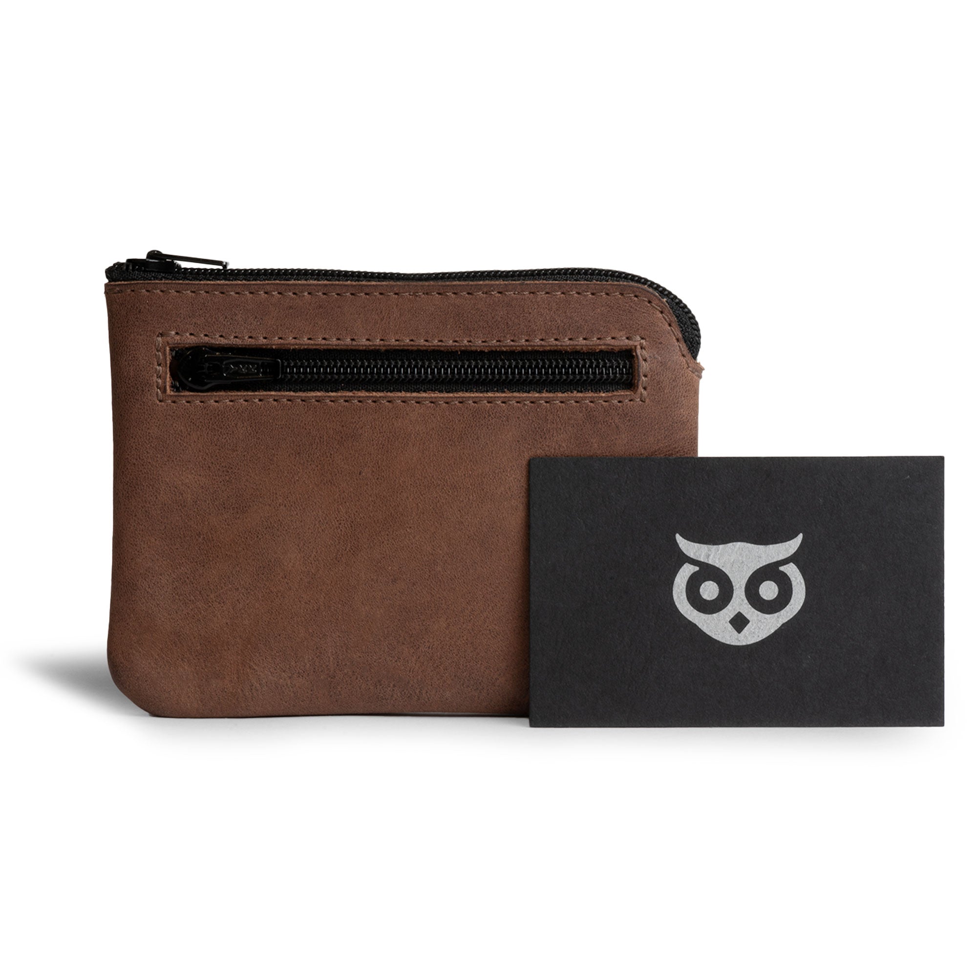 The Double Wallet Coin Pouch by Hide & Drink is shown alongside its branding card, emphasizing its Full Grain Leather design. A perfect blend of style and functionality, it highlights artisan methods including small batch production, hand cut and hand sewn techniques, and a fire branded process, handmade in La Antigua Guatemala & Oaxaca Mexico.