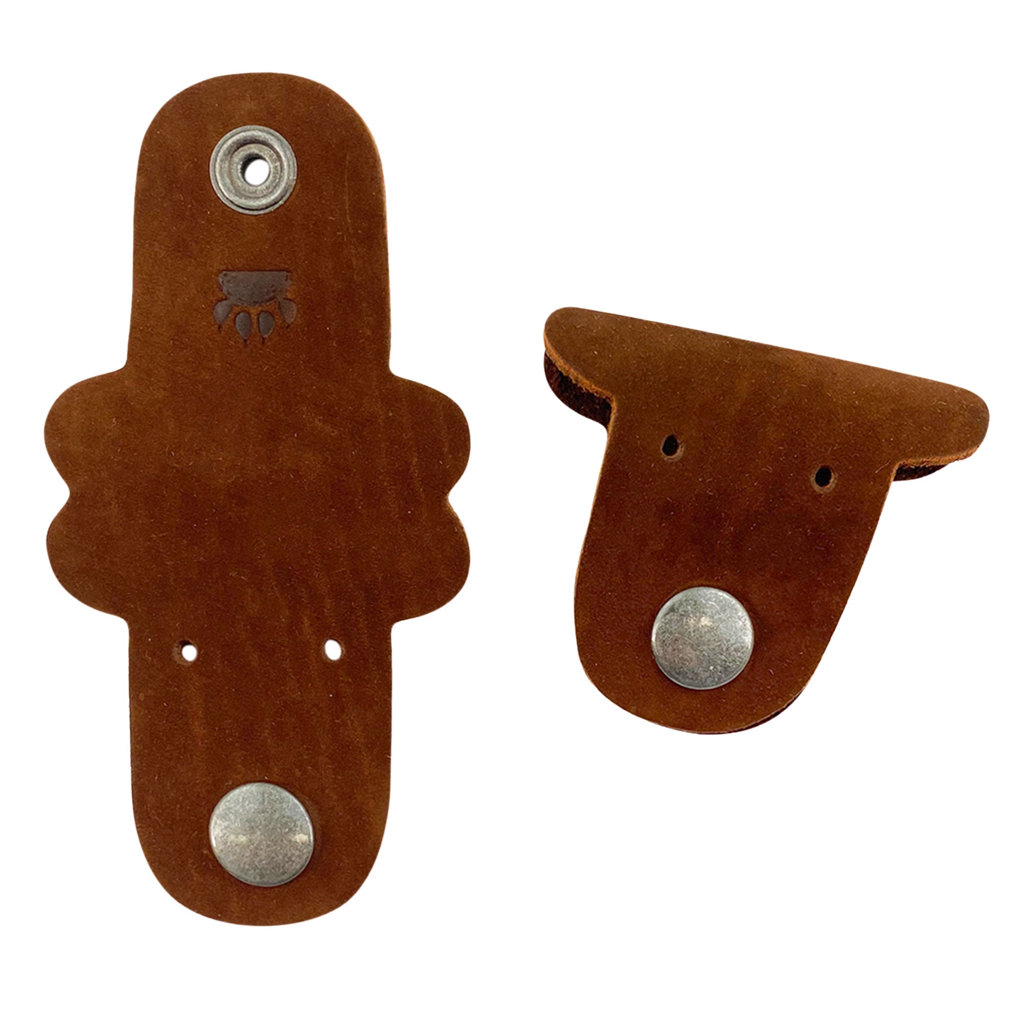 Taco Dog's brown Dog Cord Keepers combine style and functionality, uniquely designed for organizing your cables and chargers. Crafted from full grain leather, these handmade accessories feature clip snaps for easy travel management. Experience artisan workmanship from La Antigua Guatemala with this delightful setup.