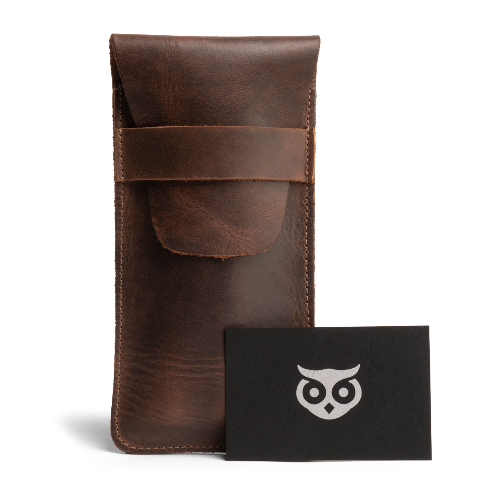 Hide & Drink Cigar Holder presented alongside a branded card, this slim cigar case for three 50 ring cigars showcases a classic design. It features a rustic portable bag made from full grain leather, artisan-made and hand sewn in La Antigua Guatemala, emphasizing quality small batch production.