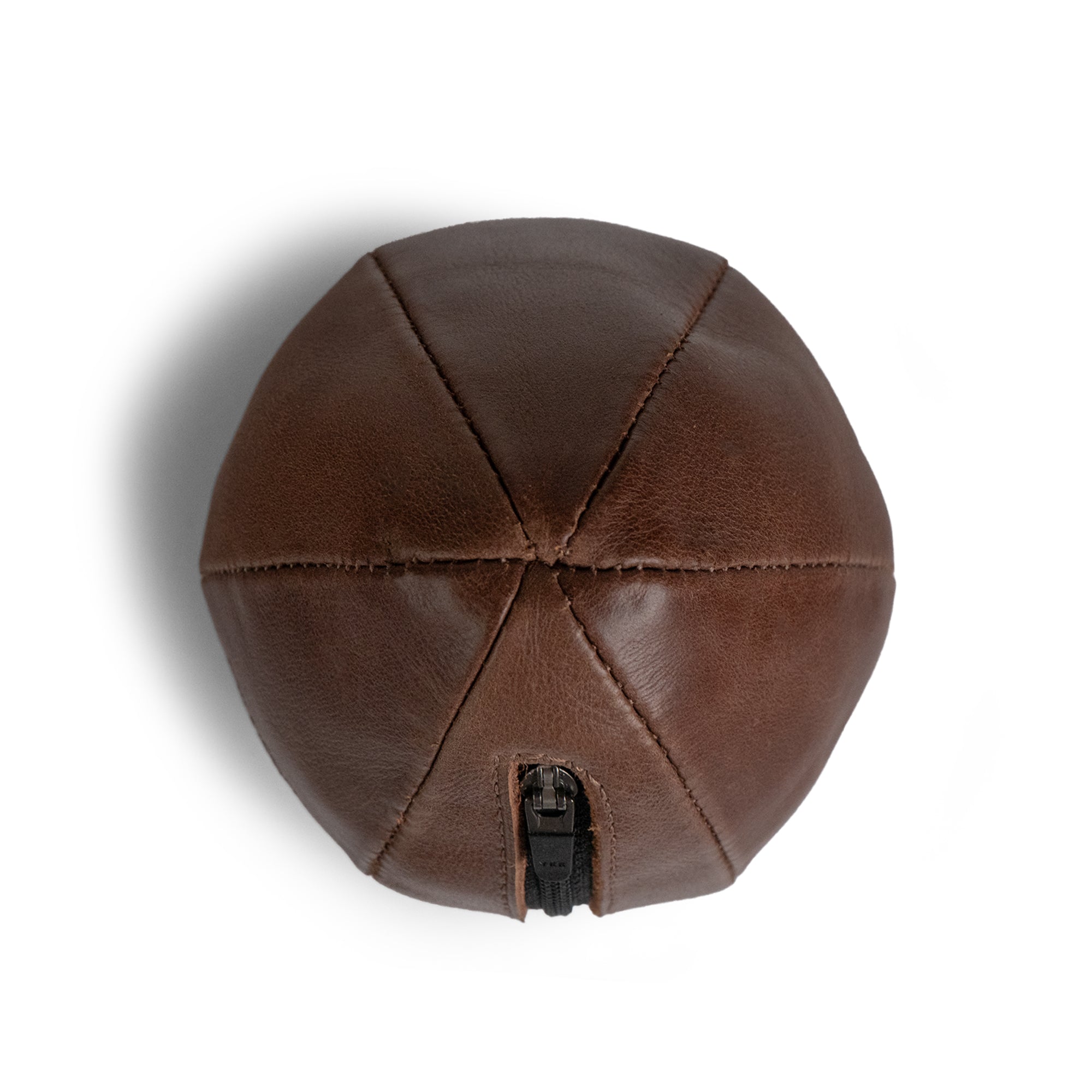 Top view of the brown Tudi Frudi Dragon Egg Pouch showing its geometric stitched panels and zipper, featuring Full Grain Leather, StockyardX Small Batch Production, Hand Cut and Hand Sewn craftsmanship, Fire Branded detail, and Artisan design Handmade in La Antigua Guatemala & Oaxaca Mexico.