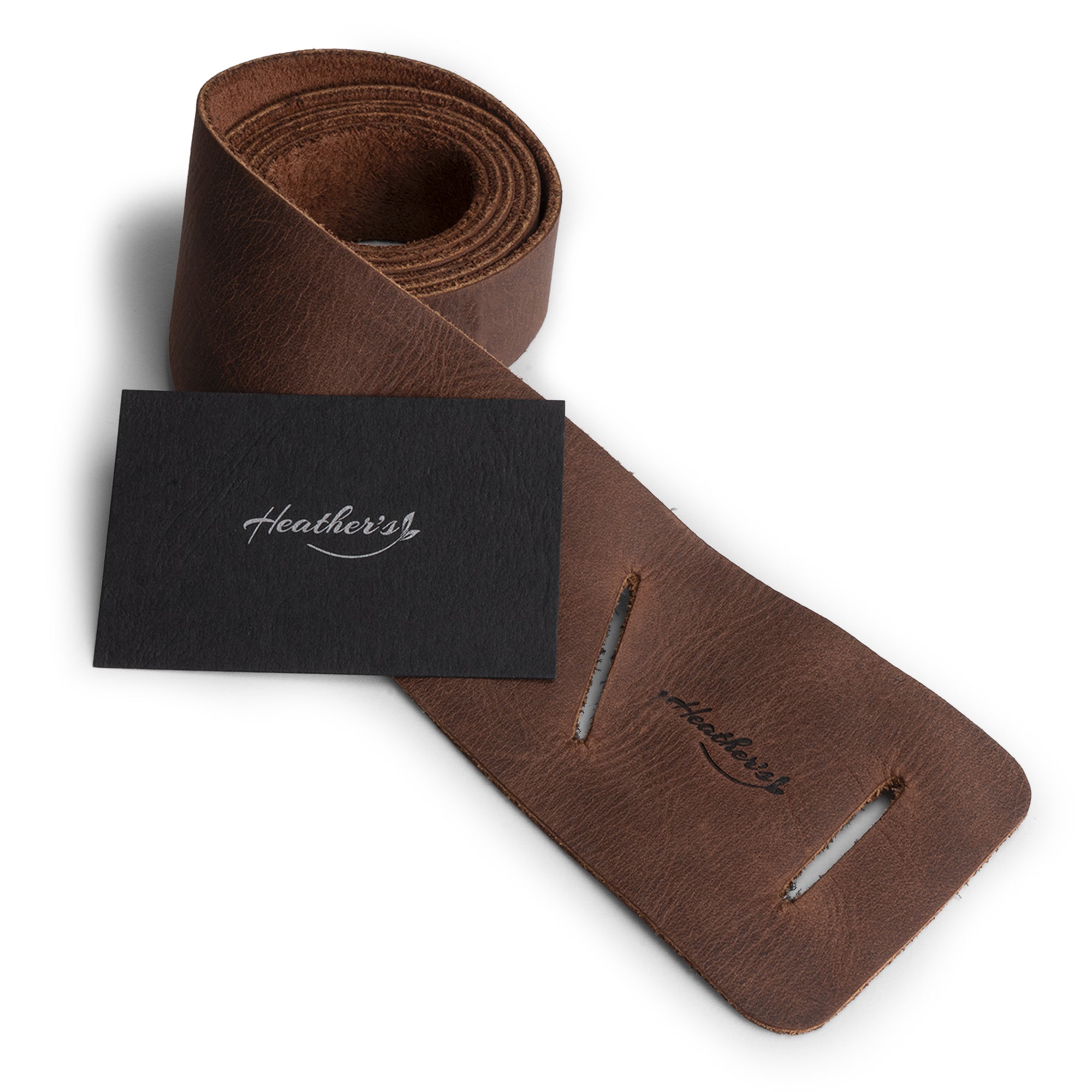 Heather's Formal Belt for Women, featuring a stylish presentation with tags highlighting its unique characteristics. This Full Grain Leather Waist Strap is a perfect example of Small Batch Production with hand cut, hand sewn, and fire branded attributes, artisan made in La Antigua Guatemala & Oaxaca Mexico.