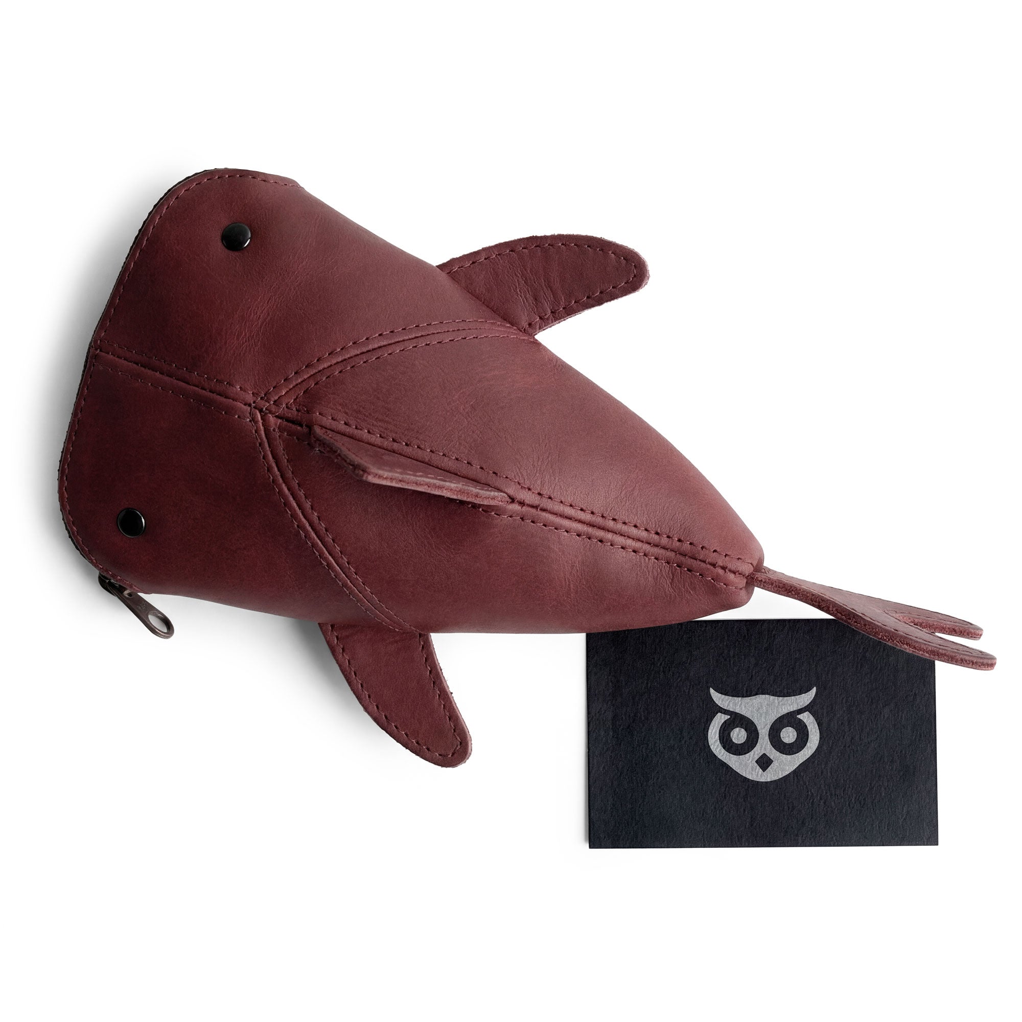 Hide & Drink Leather Shark Pouch featured with its fire-branded logo, capturing the essence of artisan quality. This handcrafted pouch can be used as a wallet, makeup case, or as a stuffed animal for kids, making it versatile beyond being just a gorgeous zippered coin pouch. Each piece is made with full grain leather, celebrating the small batch production from La Antigua Guatemala & Oaxaca Mexico.