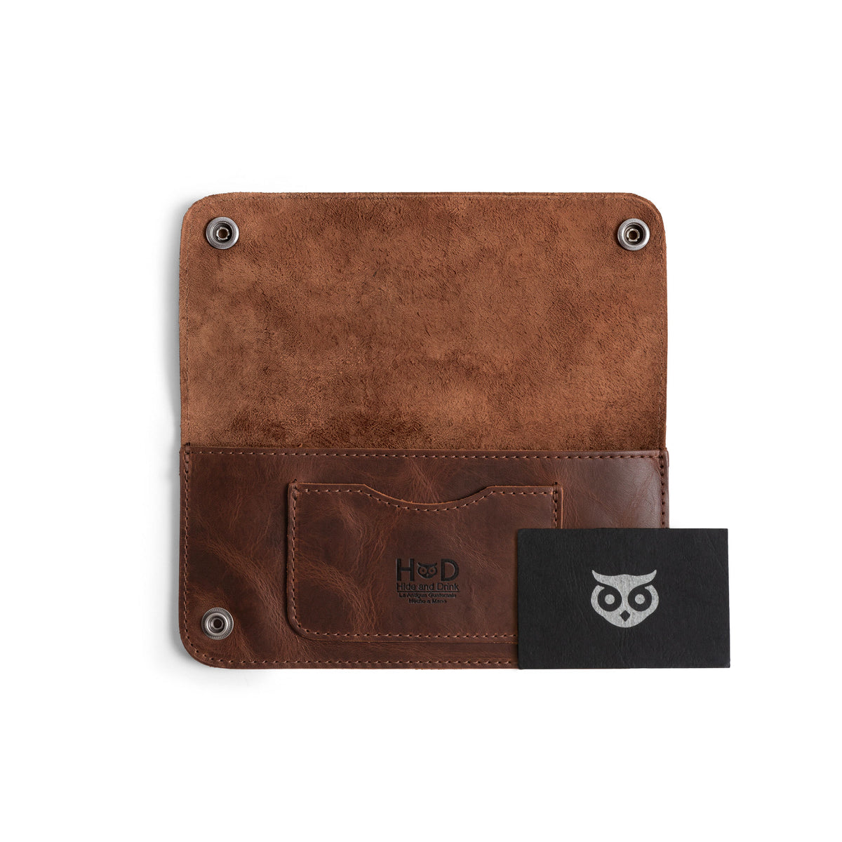 Inside view of the Brown Double Snap Folio Wallet by Hide & Drink showing a business card holder and cash slot. This elegant accessory, made from full grain leather, is perfect as a night bag or travel accessory. Artisan crafted in La Antigua Guatemala & Oaxaca Mexico, highlighting the charm of small batch production.