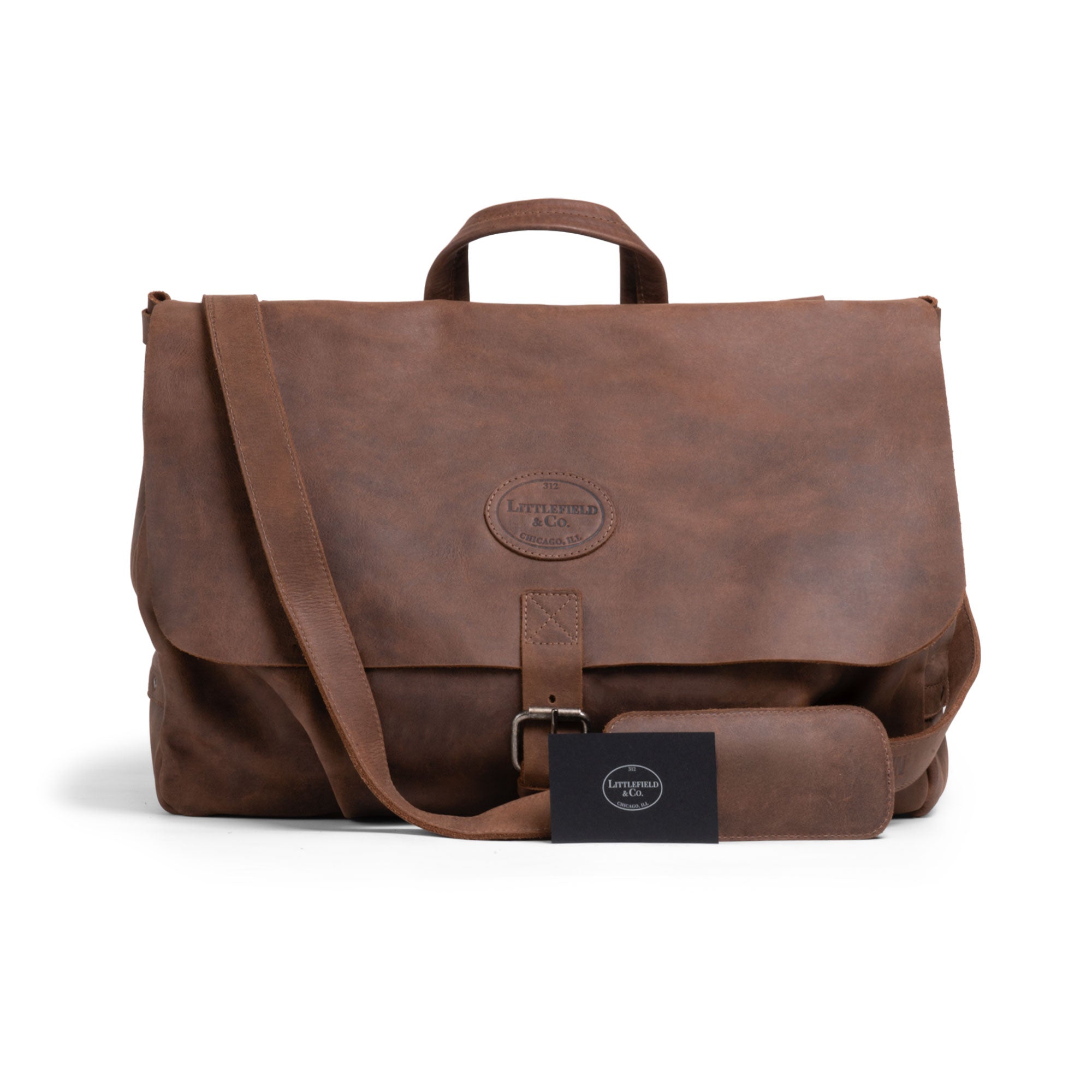 Front view of the Vintage Mail Carrier Weekend Duffle by Littlefield & Co., featuring an elegant design with a removable strap. This chic Mail Carrier Satchel with Adjustable Shoulder Strap serves as a Messenger Bag or Large Briefcase, crafted from Full Grain Leather through StockyardX's Small Batch Production, hand-cut and hand-sewn by artisans in La Antigua Guatemala & Oaxaca Mexico.