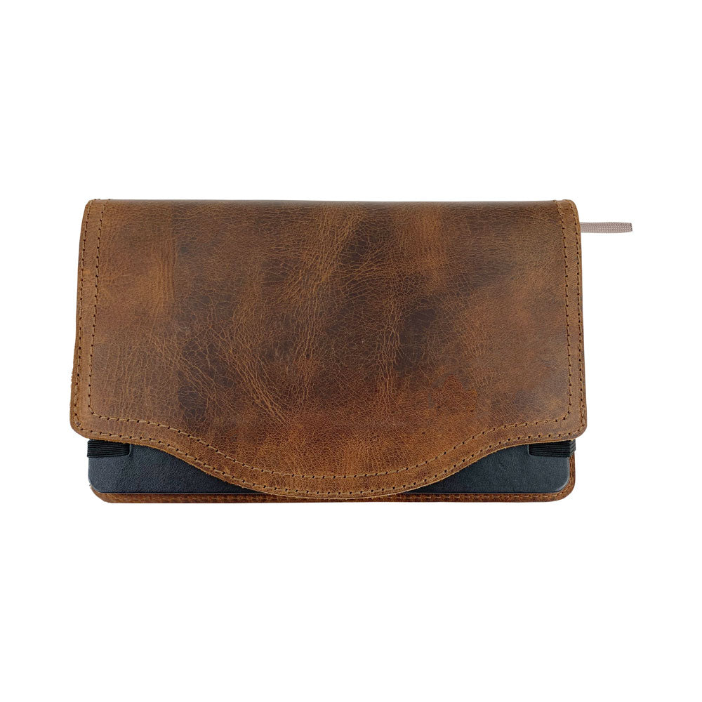 A tactile view of the Hard Cover Notebook Protector (Notebook NOT Included) by Hide & Drink, focusing on its leather texture. Designed for Moleskine Hard Cover Sketchbook XXL Size (8.5 x 11 in.), Notebook NOT Included, this journal cover utilizes Full Grain Leather within StockyardX’s small batch production, ensuring quality through hand cut, hand sewn, and fire branded skills by artisans. Handmade in La Antigua Guatemala & Oaxaca Mexico.