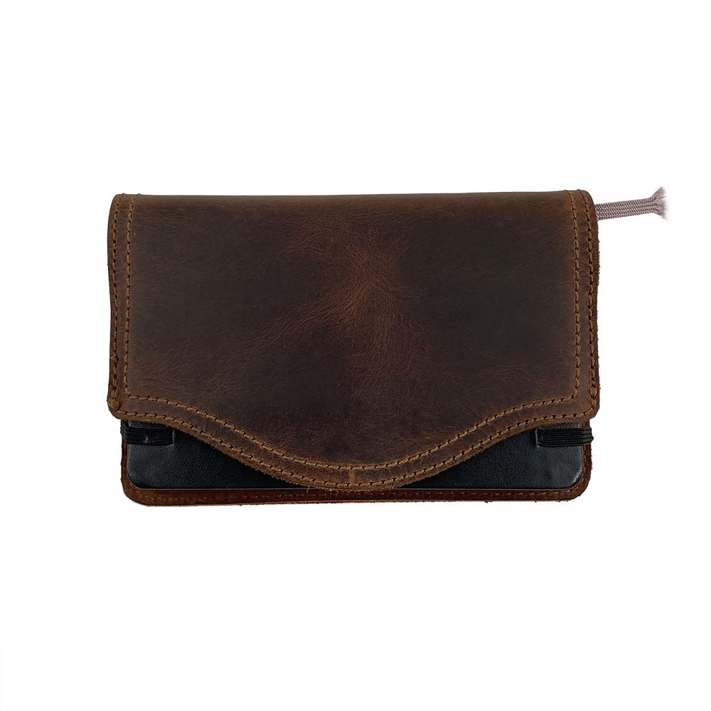 A stylish edge view of the Hard Cover Notebook Protector (Notebook NOT Included) by Hide & Drink, depicting its rich texture. This journal cover is specifically for Moleskine Hard Cover Sketchbook XXL Size (8.5 x 11 in.), Notebook NOT Included, crafted from high-quality Full Grain Leather as part of StockyardX’s small batch production, showcasing skill through hand cut, hand sewn, and meticulously fire branded methods by artisans. Handmade in La Antigua Guatemala & Oaxaca Mexico.