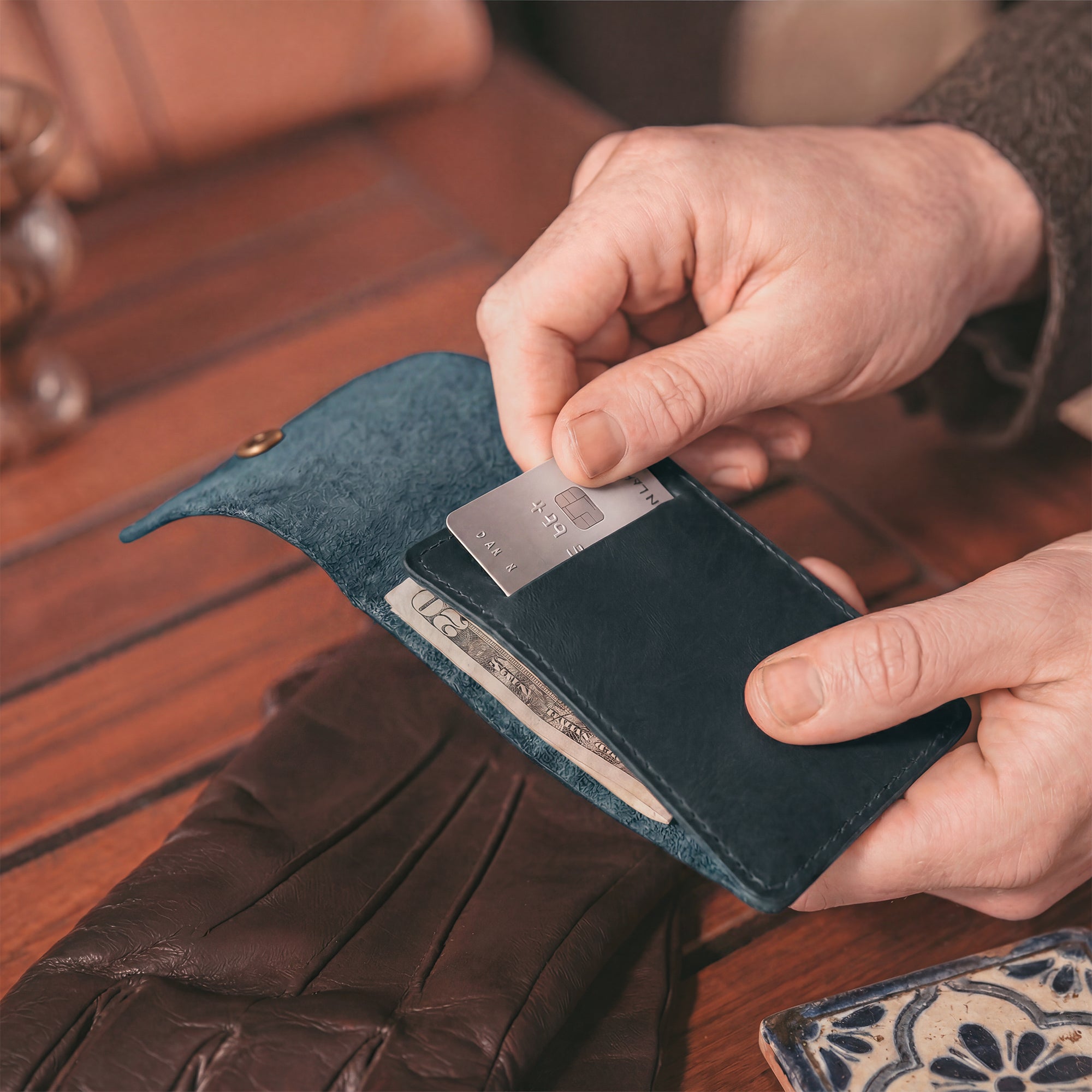 Interior view of the blue Vertical Wallet by Hide & Drink showcasing compartments for cards and notes. This Vertical Front Pocket Wallet with Card Slot provides a stylish solution for compact storage, made from durable full grain leather through small batch production techniques, hand cut and hand sewn with fire branding. Handmade in La Antigua Guatemala & Oaxaca Mexico.