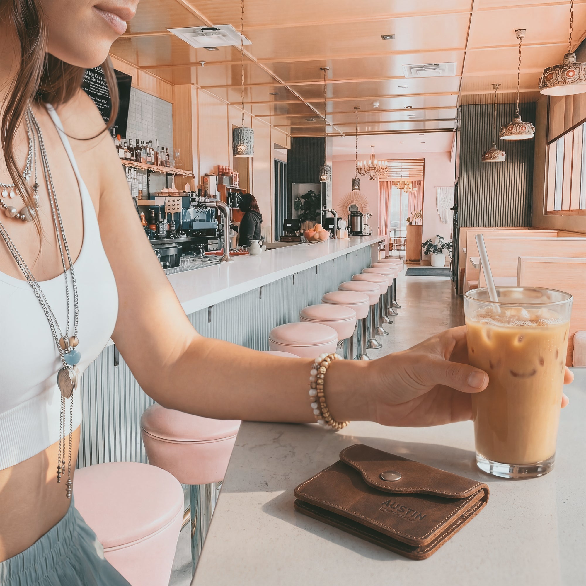 The Hyde Card Wallet pictured in a stylish café setting, made from full grain leather, highlighting the artisan touch of Austin Genuine in small batch production for a sophisticated accessory.