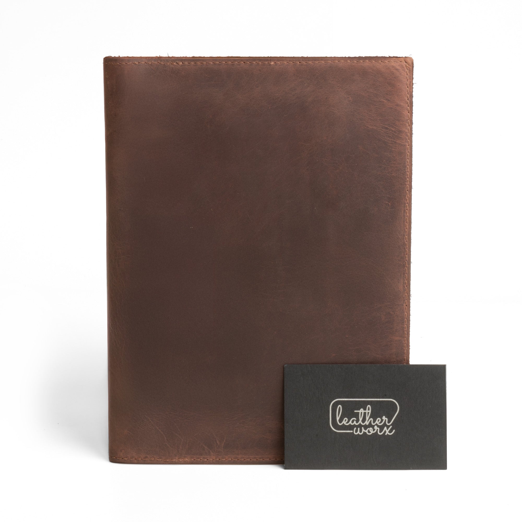 Front view of the Leather Worx Notepad Case 5 x 8 In. with a sleek design, accompanied by a branded card showcasing its artisan quality. Notepad Cover (5 x 8 In. Notepad Not Included) Sturdy, Durable Material Perfect for Storing Journal, Full Grain Leather, StockyardX, Small Batch Production, Hand Cut, Hand Sewn, Fire Branded, Artisan, Handmade in La Antigua Guatemala & Oaxaca Mexico.