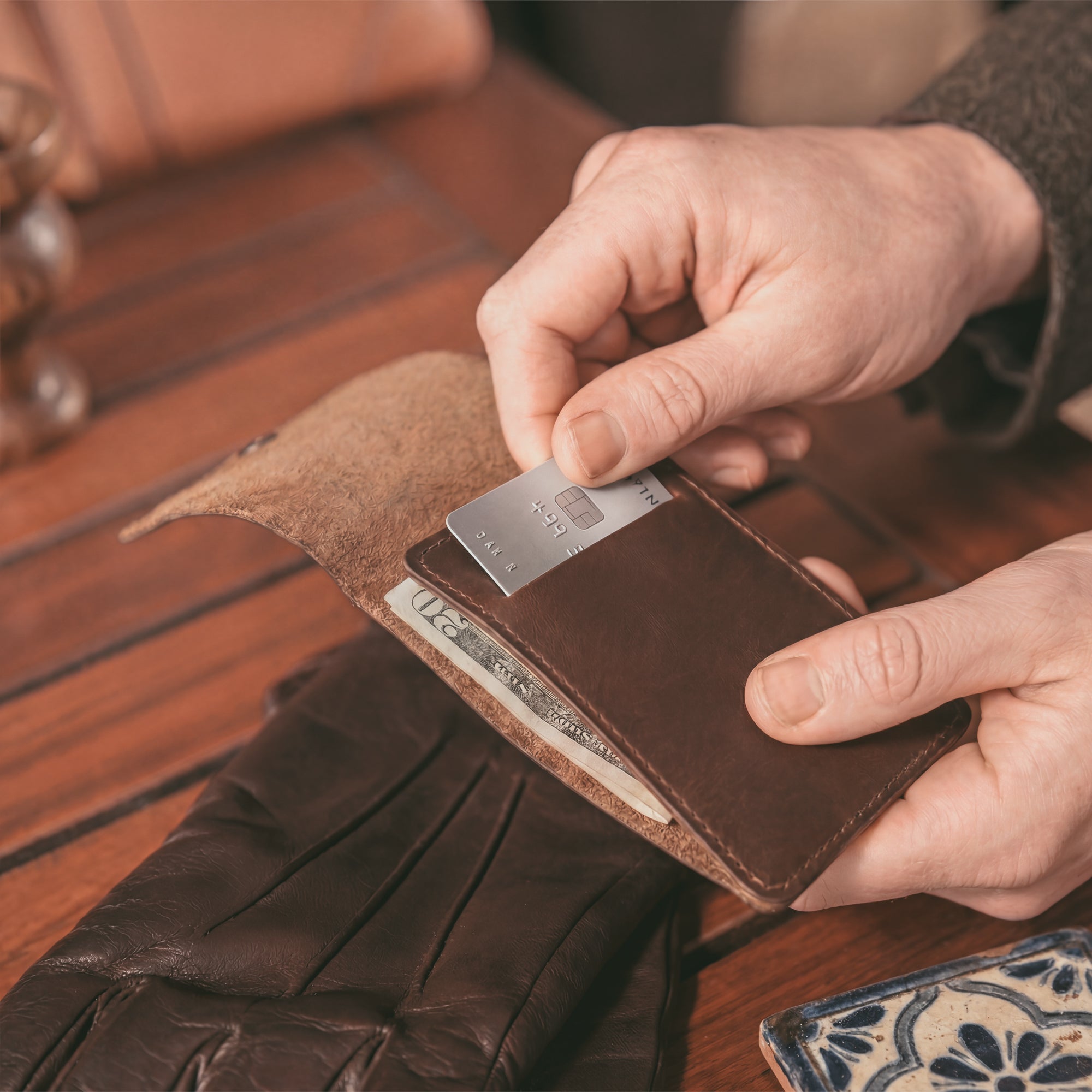 Interior view of the Vertical Wallet by Hide & Drink displaying storage for cards and cash, a perfect compact storage solution. This Vertical Front Pocket Wallet with Card Slot is made of full grain leather, representing small batch production with hand cut and hand sewn finishes, fire branded by artisans. Handmade in La Antigua Guatemala & Oaxaca Mexico.