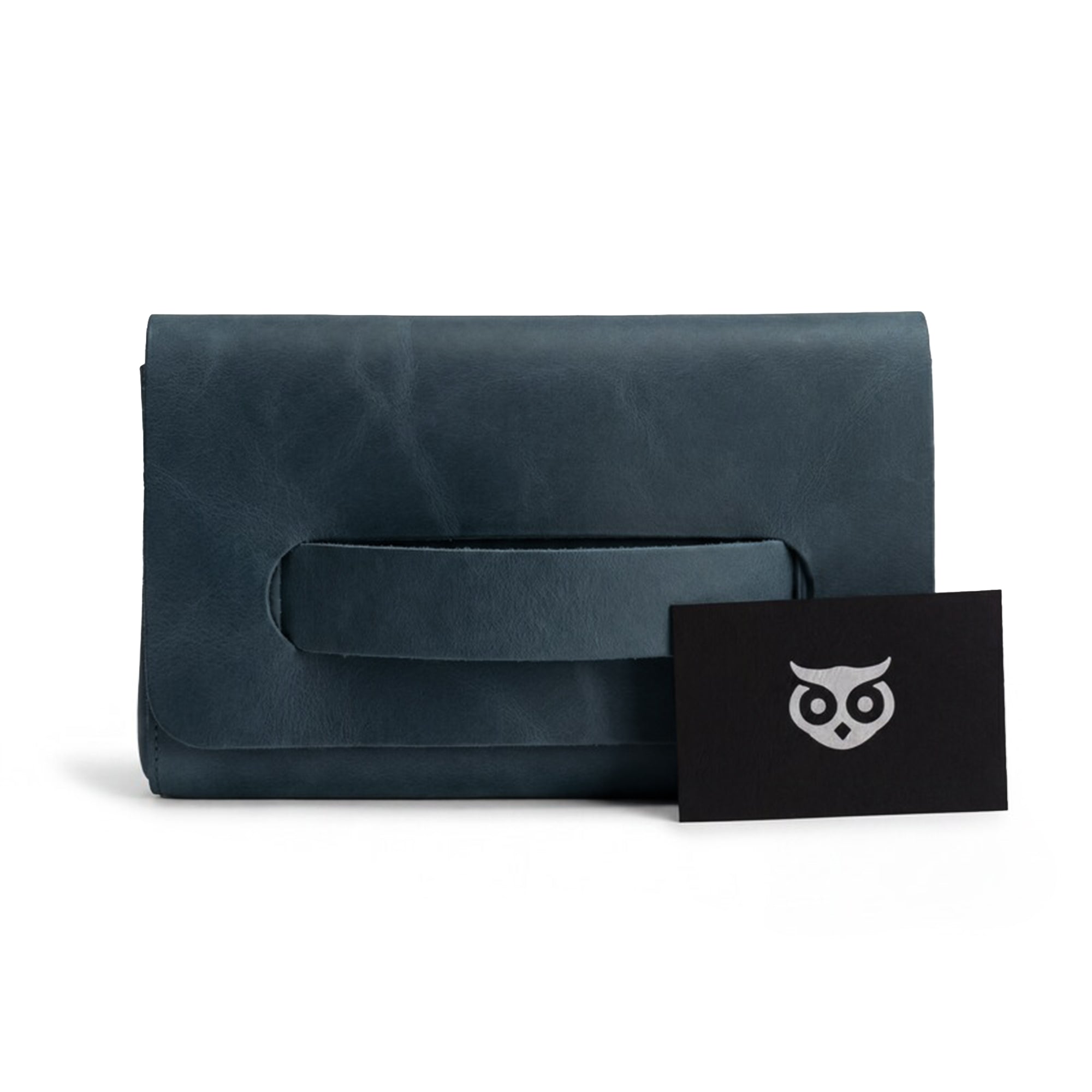 The navy Clutch Bag With Handle from Hide & Drink displayed with included accessories. This Full Grain Leather Clutch Bag is a stylish gift for women, crafted with care and precision in Guatemala and Mexico.