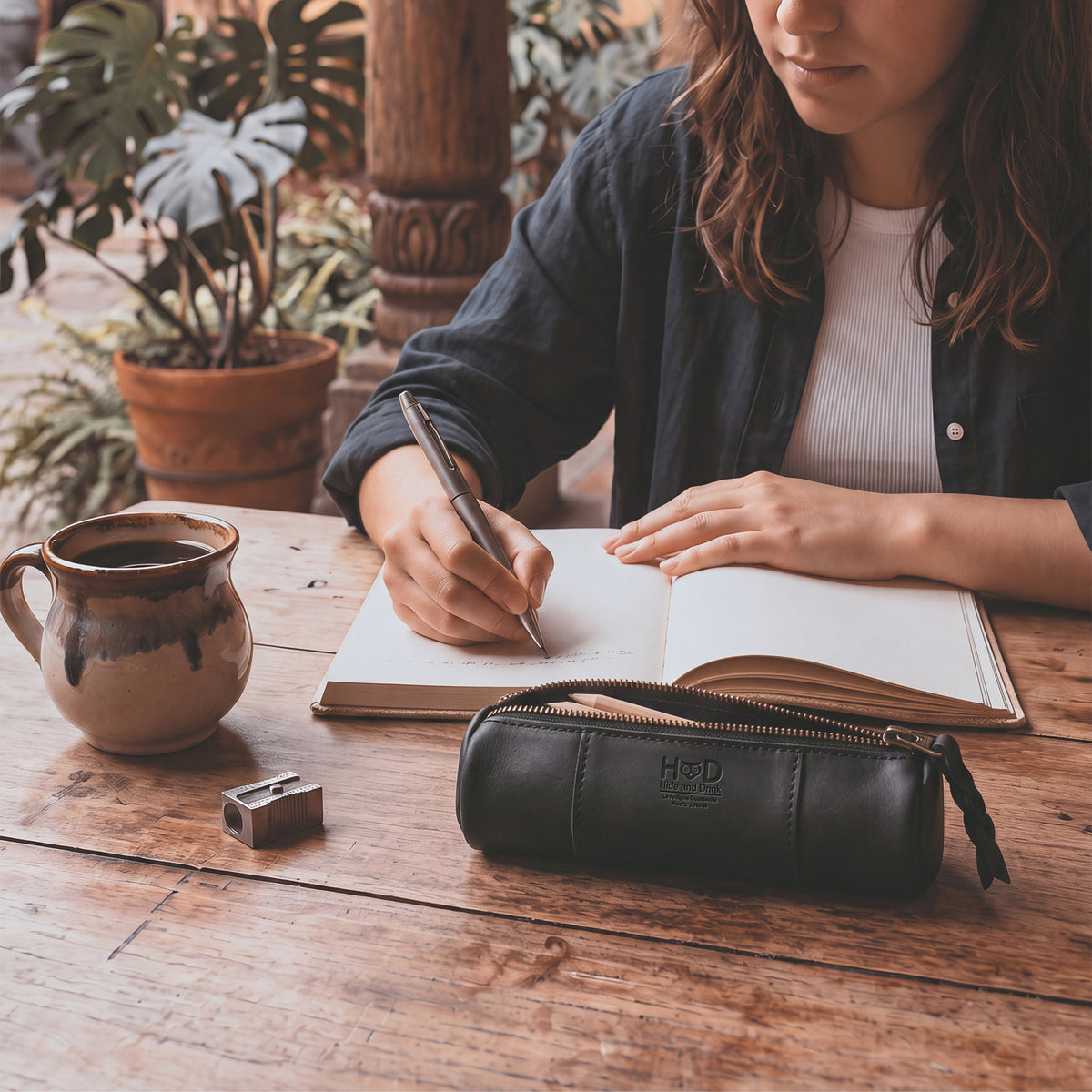 Utility Cylinder Case by Hide & Drink in black leather, designed for personal items or office supplies. This small batch, artisan bag showcases the beauty of Full Grain Leather craftsmanship. Cylinder Case, Classic Bag, Handmade.