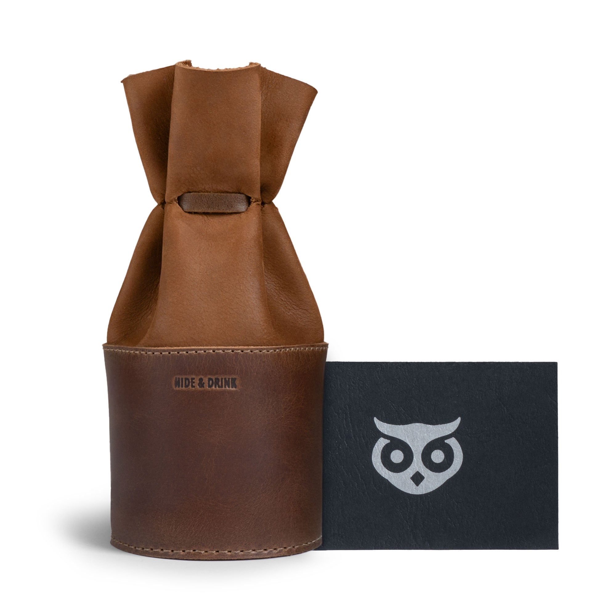 The Medieval Bucket Coin Release by Hide & Drink displayed with its artisan branding emphasizes its quality as a piggy bank bucket. This full grain leather coin pouch is a stylish cash organizer and cylinder case for pennies, hand cut and sewn with care, reflecting the craftsmanship of artisans in La Antigua Guatemala & Oaxaca Mexico.