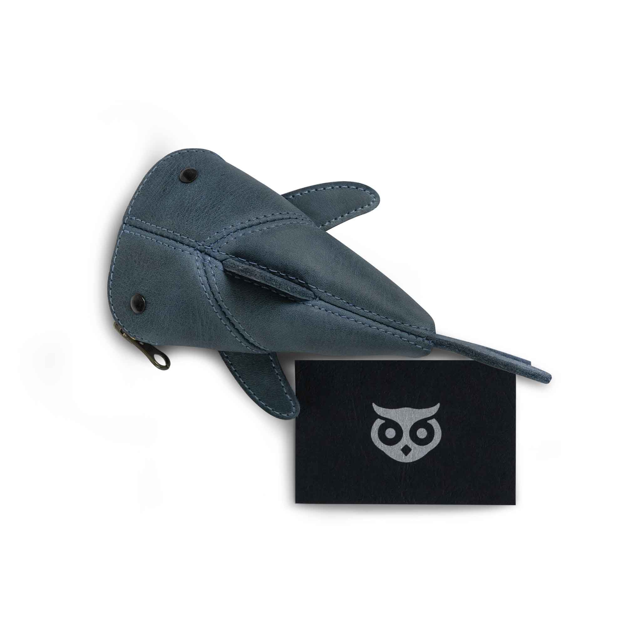 Hide & Drink Leather Shark Pouch with a branded card. This charming small shark-shaped pouch is perfect as a Leather Coin Purse and a small charger cable holder. Ideal for cash, it serves as a change bag or zippered cable case. Crafted with love from full grain leather, this pouch is part of small batch production, hand cut, hand sewn, fire branded, and artisan-made in La Antigua Guatemala & Oaxaca Mexico.