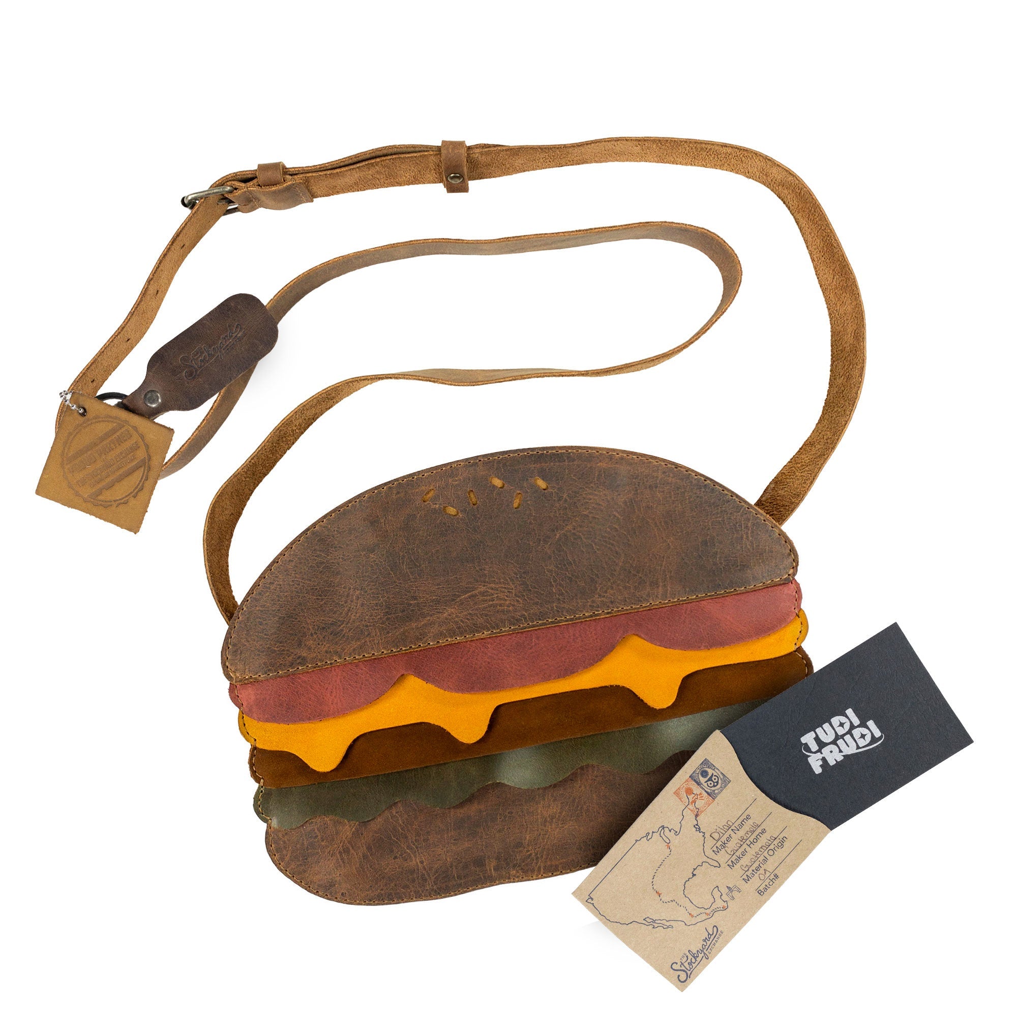 Burger-Shaped Shoulder Bag from Tudi Frudi presented with accompanying packaging, showcasing the unique artisan craftsmanship. This Full Grain Leather bag stands out as a fantastic Crossbody Bag or Messenger Bag, blending style with practicality. Handmade in La Antigua Guatemala & Oaxaca Mexico, it's a charming travel accessory from small batch production.