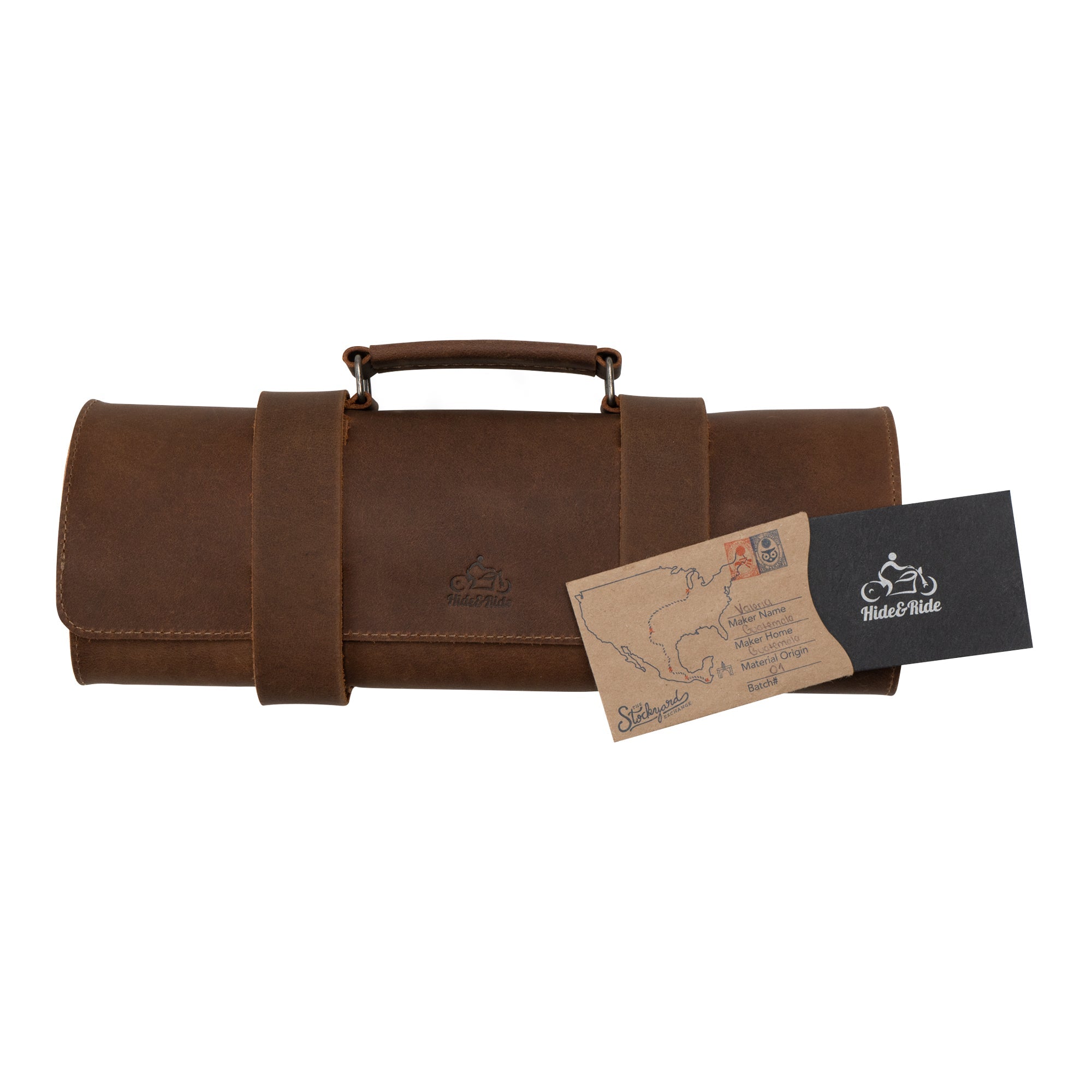 Closed Tool Roll for Bikers with a postcard, featuring the craftsmanship of Hide & Ride. This Motorcycle Tool Bag serves as a Universal Saddlebag for Motorcycle and Fork Bag for Bikers, made from sturdy Full Grain Leather. Appreciate the artistry in this Small Batch Production item, which is Hand Cut and Hand Sewn, finished with Fire Branding by skilled artisans in La Antigua Guatemala & Oaxaca Mexico.