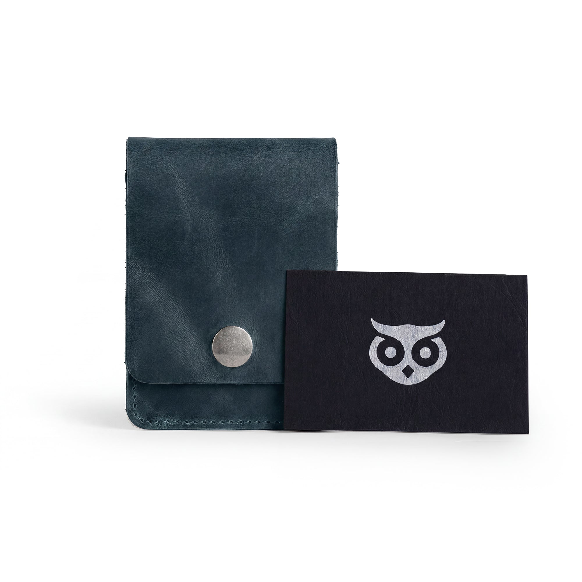 Vertical Wallet by Hide & Drink styled with business cards to illustrate daily utility. This Vertical Front Pocket Wallet with Card Slot offers compact storage options for money and cards, crafted from premium full grain leather showcasing small batch production, hand cut, hand sewn, and fire branded craftsmanship. Handmade in La Antigua Guatemala & Oaxaca Mexico.