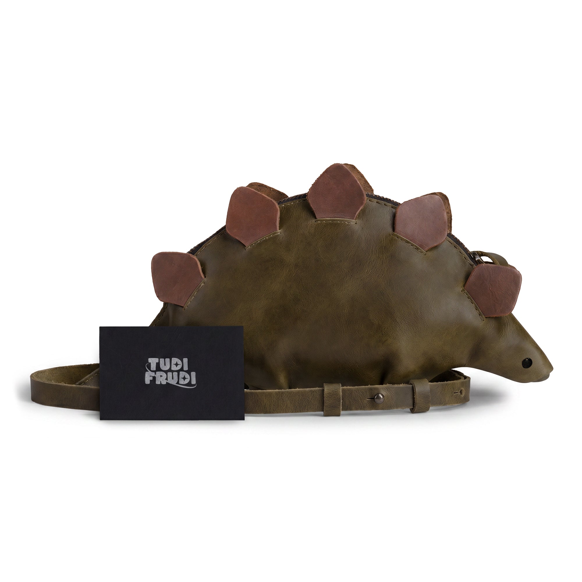 Dinosaur-Shaped (Stegosaurus) Shoulder Bag by Tudi Frudi with the included product tags, showcasing its distinct design and Full Grain Leather materials. Perfect as a Crossbody Bag, it reflects the Artisan skill and Small Batch Production ethos from La Antigua Guatemala & Oaxaca Mexico.