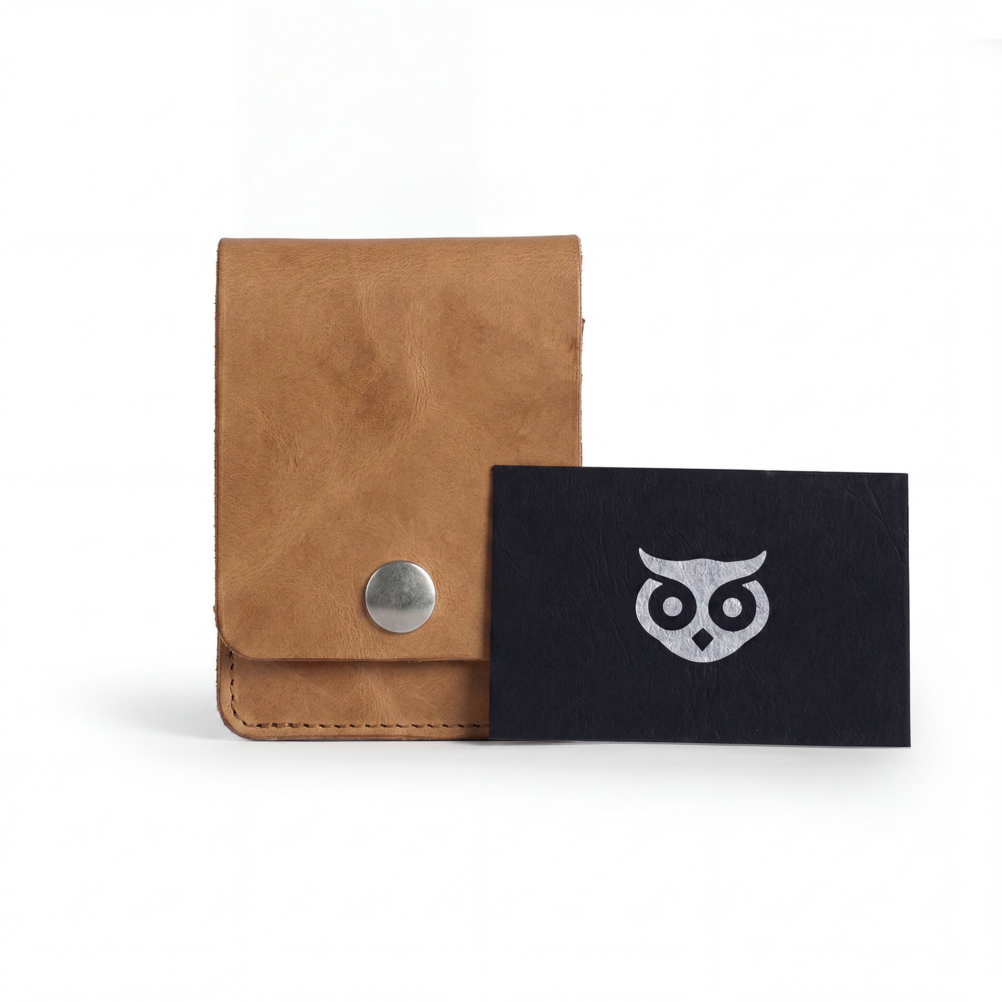 Vertical Wallet by Hide & Drink styled with business cards to showcase versatility. This Vertical Front Pocket Wallet with Card Slot presents compact storage solutions for bills and cards, made from durable full grain leather, emphasizing small batch production, hand cut, hand sewn with fire branding for a stylish touch. Handmade in La Antigua Guatemala & Oaxaca Mexico.