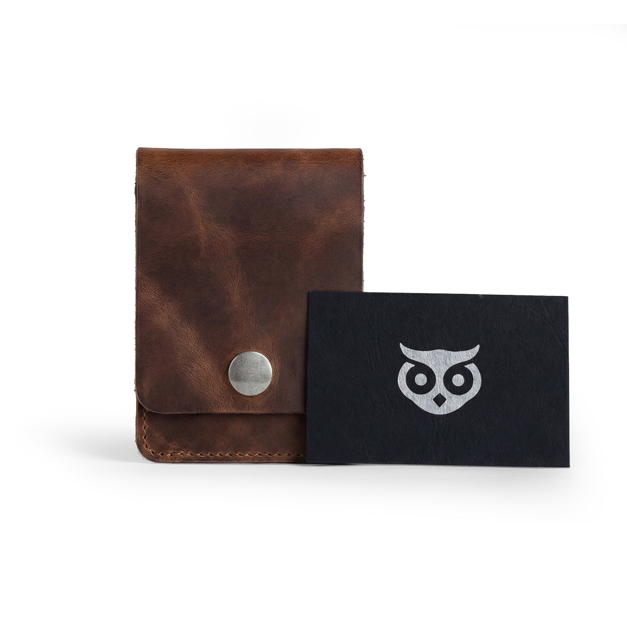 Vertical Wallet by Hide & Drink displayed with business cards, emphasizing its versatility. This Vertical Front Pocket Wallet with Card Slot is designed for compact storage of bills and cards, made of full grain leather in small batch production, featuring hand cut and hand sewn finishes with fire branded details. Handmade in La Antigua Guatemala & Oaxaca Mexico.