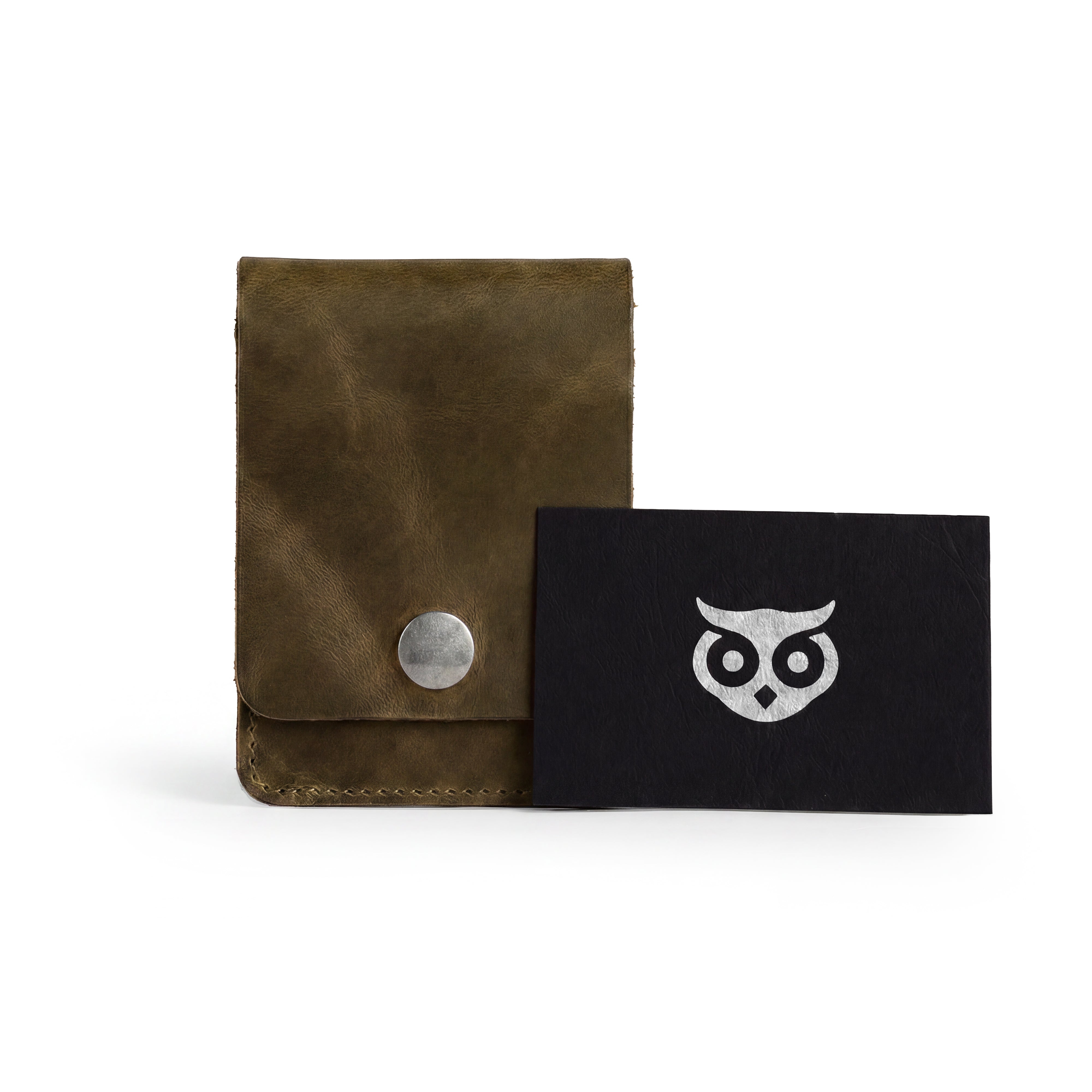 Vertical Wallet by Hide & Drink presented with business cards showcasing its daily utility. This Vertical Front Pocket Wallet with Card Slot is perfect for compact storage of cash and cards, crafted from full grain leather emphasizing small batch production, featuring hand cut, hand sewn details, and fire branded artistry. Handmade in La Antigua Guatemala & Oaxaca Mexico.