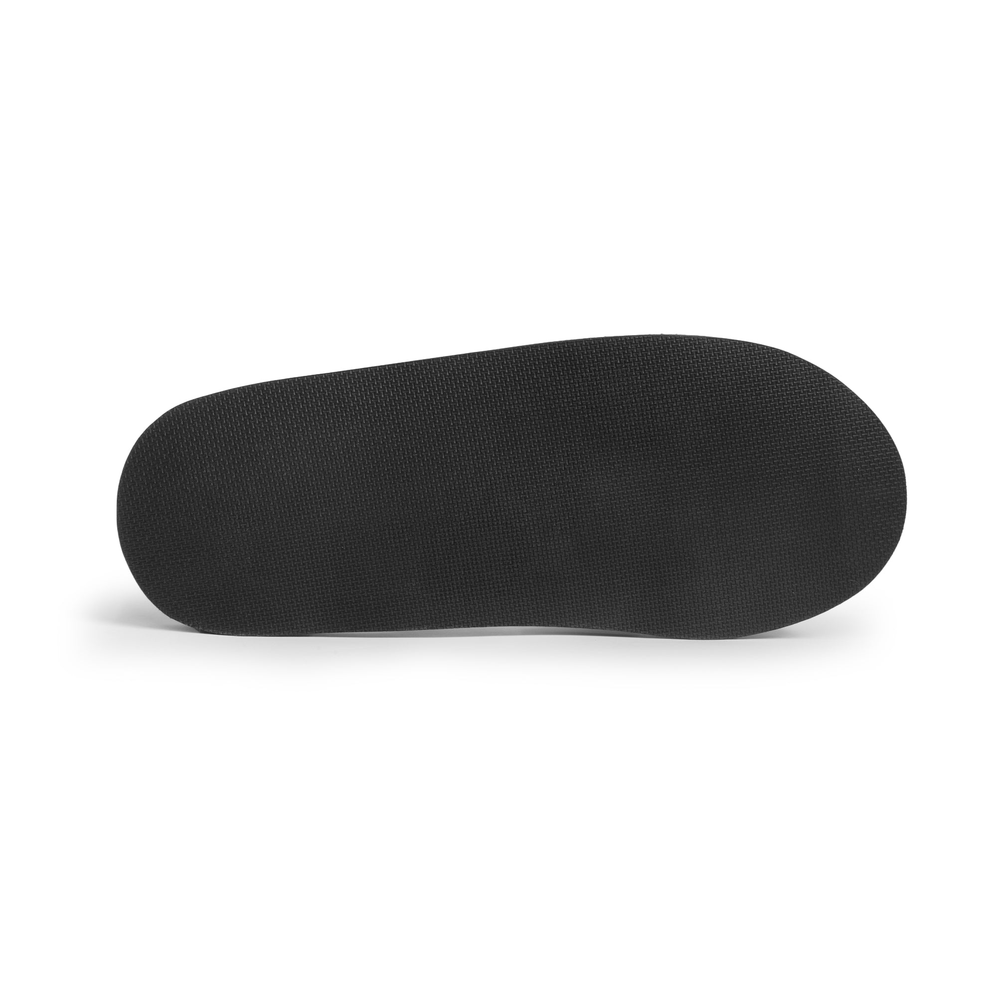 The underside of The Wanderer Arch Comfort Sandals, showcasing the durable sole designed for optimal grip and support. Made by La Leche, these sandals incorporate soft cushioning for arch support and are intended for both indoor lounging and outdoor escapades, reflecting small batch, artisan workmanship.