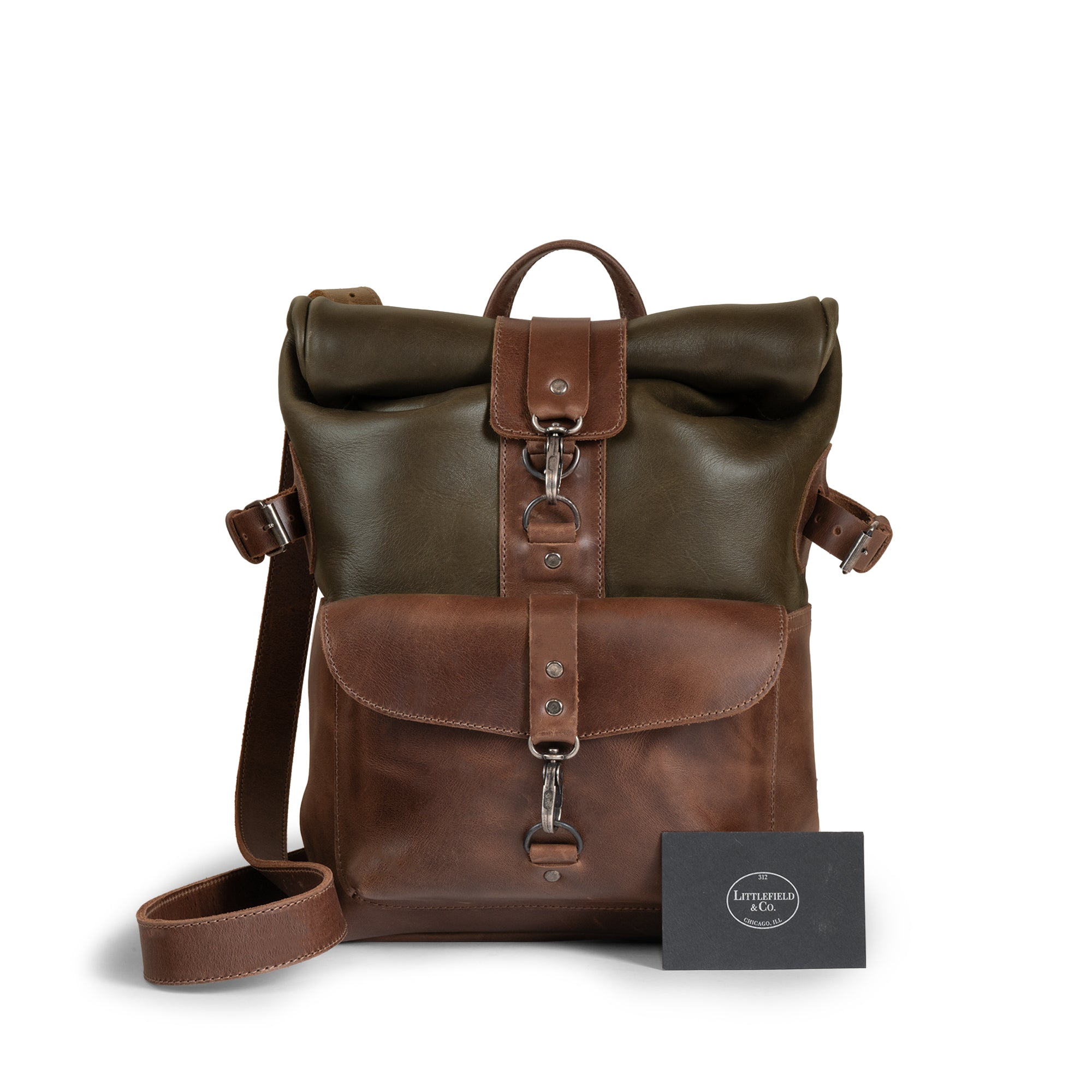 The Vintage Adventure Crossbody Bag by Littlefield Chicago displayed with a card. This artisan crafted leather adventure crossbody bag features an adjustable strap and a unique design, making it an ideal small batch production messenger bag for travel and outdoor use.