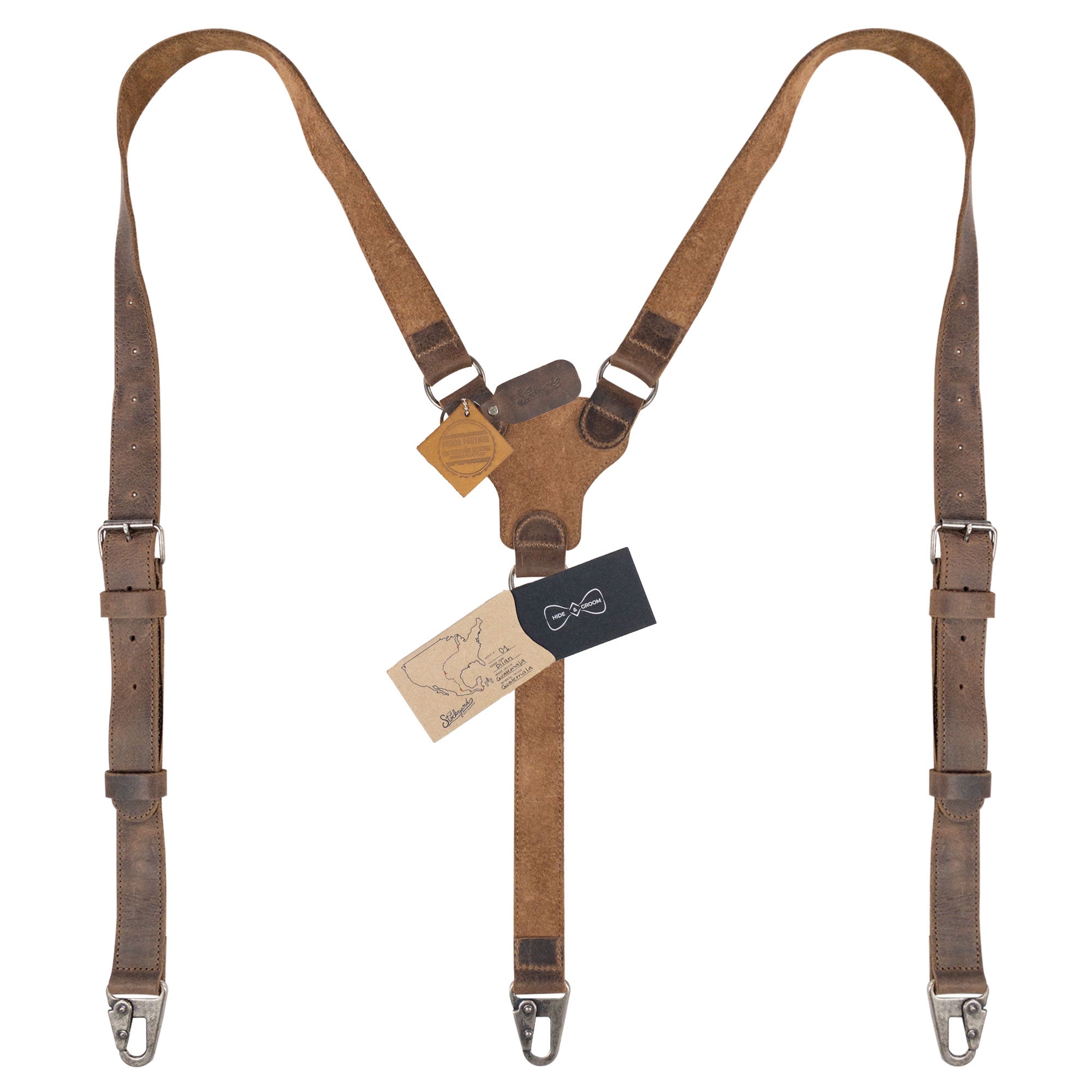 Leather Y Back Formal Suspenders by Hide & Groom with tags attached, showcasing their handmade quality. These Full Grain Leather Y Back Formal Suspenders are a unique touch for weddings, blending Steampunk Style with artisan craftsmanship from La Antigua Guatemala.