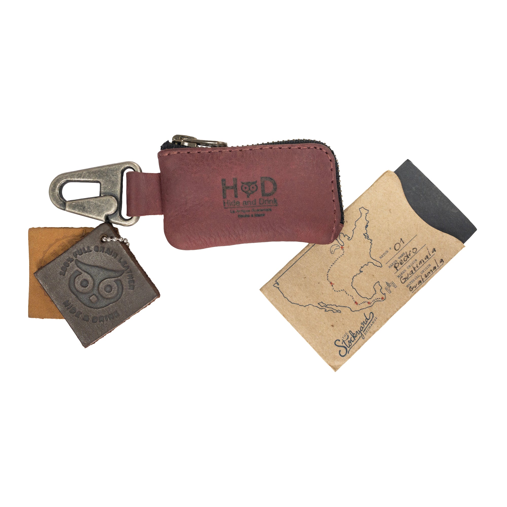 Car Key Holder with Tag by Hide & Drink, highlighting the quality of craftsmanship and features for organizing keys and cash. This bag additionally holds Headphone and charging Cables, Memory Cards, and Flash Drives, made of sturdy Full Grain Leather, with a Nickel Metal Clasp, reflecting Small Batch Production and Artisan skills from La Antigua Guatemala & Oaxaca Mexico.