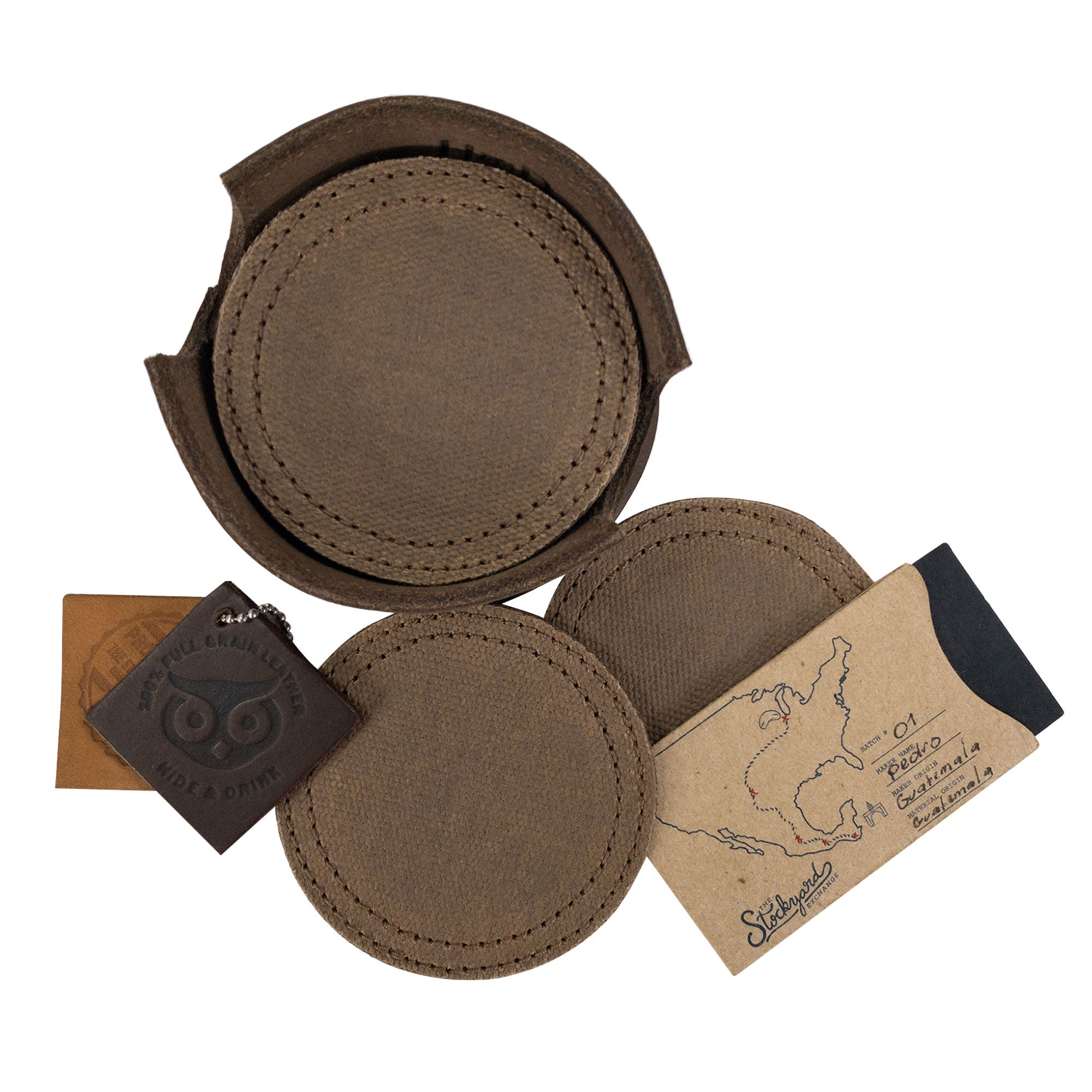 Coasters with tags displayed from the brown-colored Set of 8 Circular Coasters for Drinks by Hide & Drink. Designed to protect Glass & Cups from stains, this set is made from quality Waxed Canvas and Full Grain Leather. Experience the StockyardX approach with these Small Batch Production coasters, which are Hand Cut, Hand Sewn, Fire Branded, and made Artisan, Handmade in La Antigua Guatemala & Oaxaca Mexico.