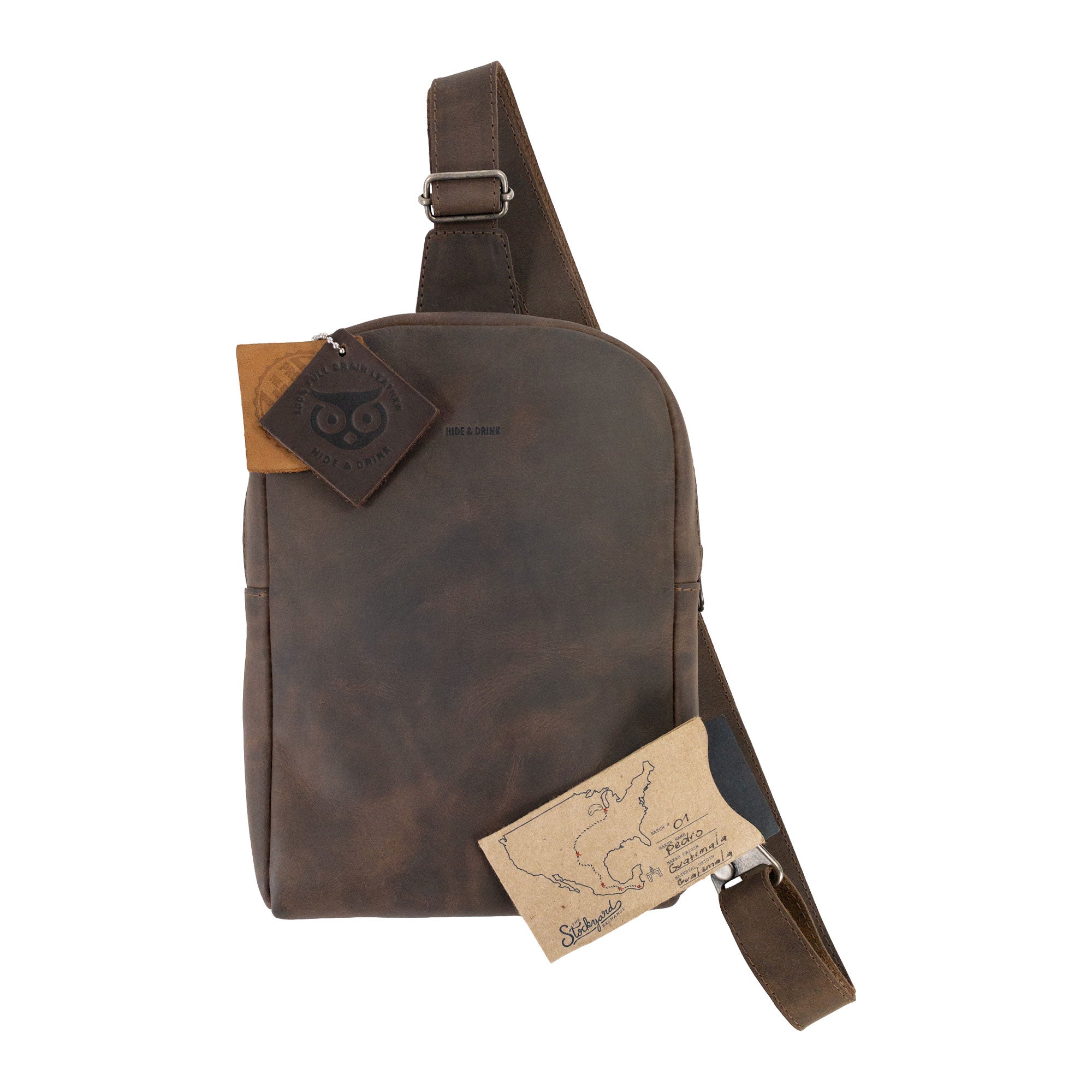 The back view of the Hide & Drink Crossbody Rounded Bag, featuring the brand's signature detailing. This Rounded Crossbody Bag with Adjustable Strap is an excellent choice for a messenger bag, made from durable Full Grain Leather, showcasing artisan techniques from La Antigua Guatemala & Oaxaca Mexico.