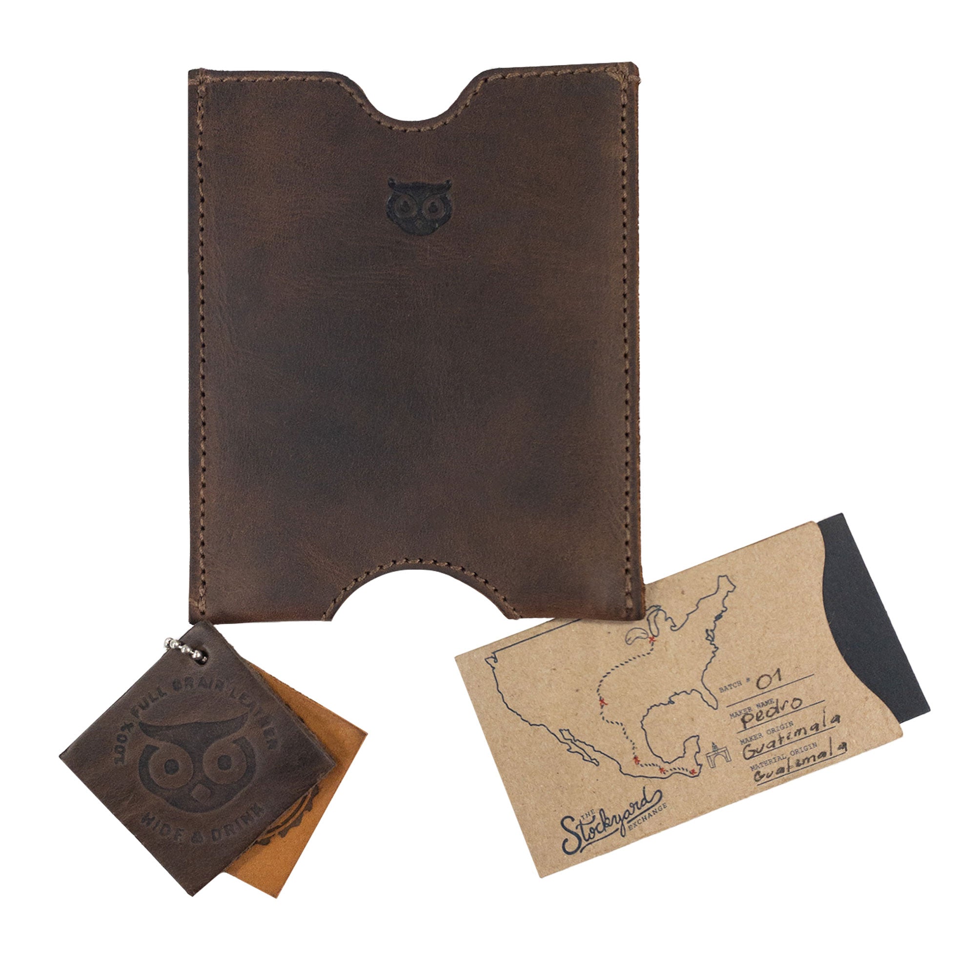 Hide & Drink Passport Sleeve presented with branding tags, showcasing its artisanal heritage. This Travel Passport Pocket Sleeve is handcrafted from Full Grain Leather, fire branded, and represents the essence of small batch production.